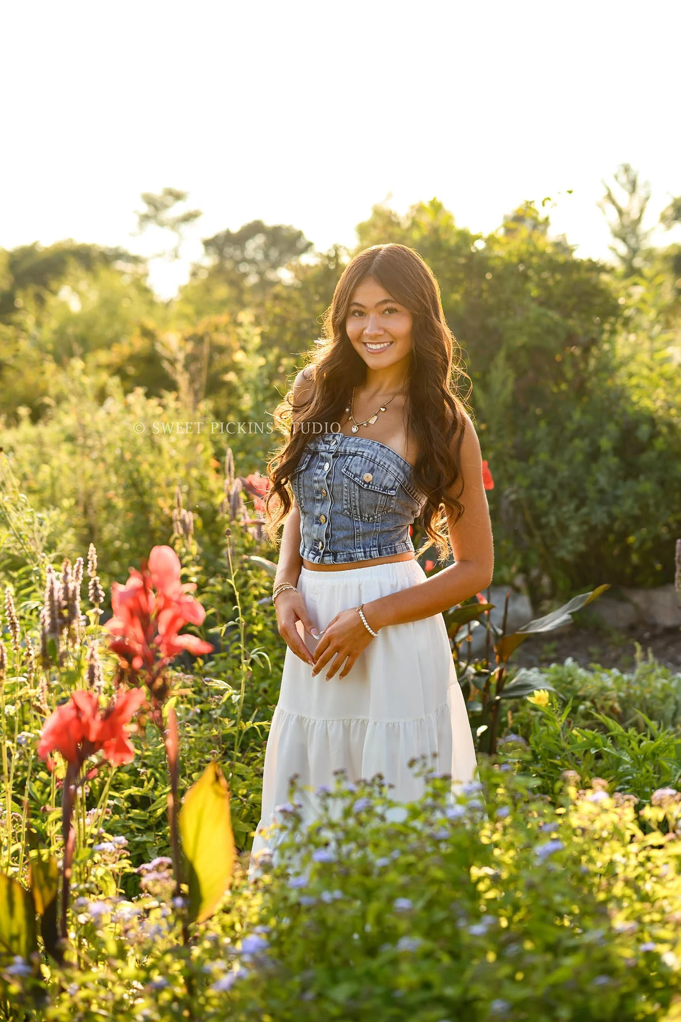Rachel | Carmel, Indiana Floral Senior Pictures in Garden at sunset for Class of 2027 senior girl wearing denim crop top and white skirt in flowers by Sweet Pickins Studio senior photographer Amanda Wilson ©