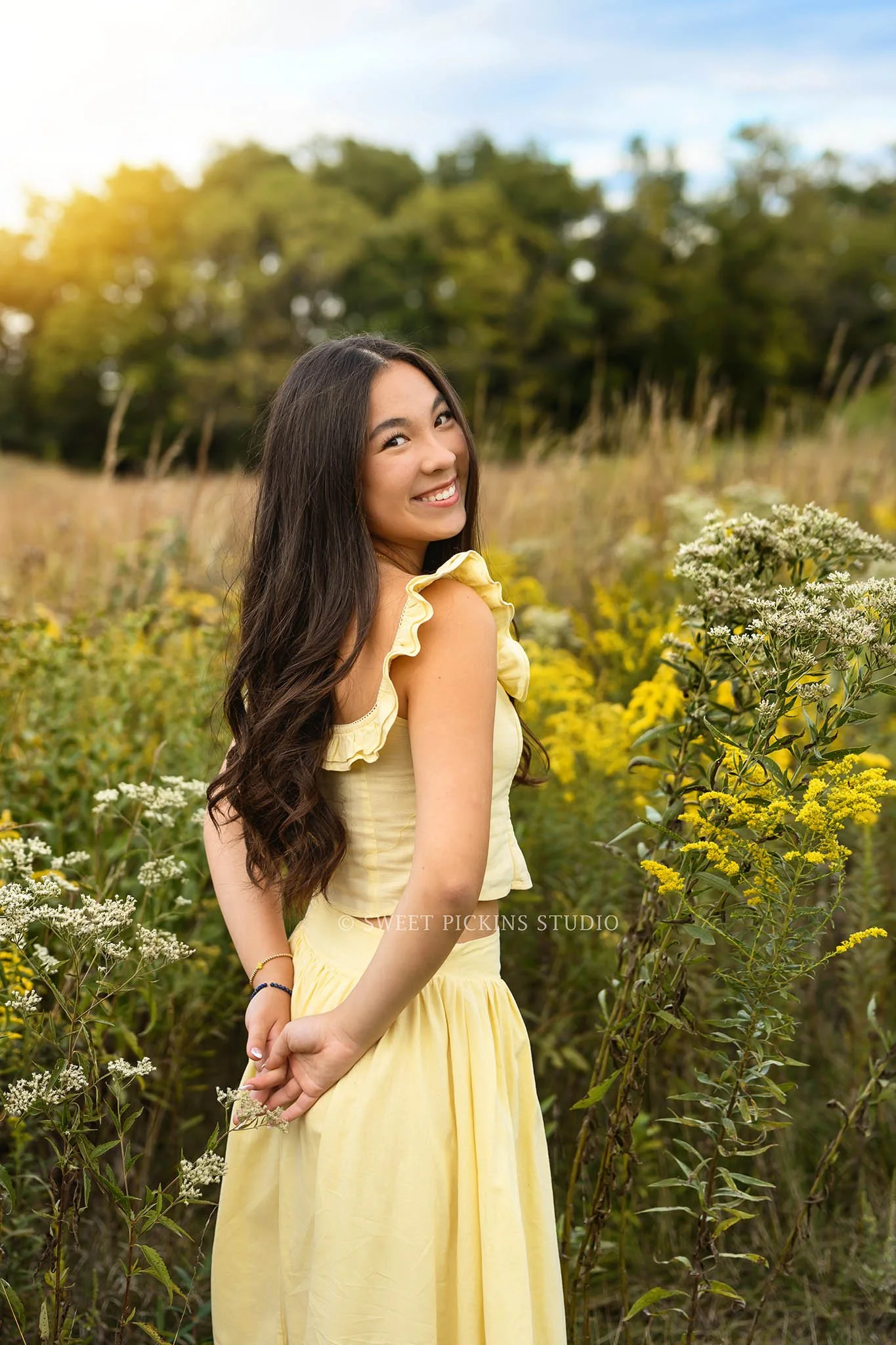 Nora | Carmel, Indiana Fall Senior Girl Photography in wildflower field with flowers wearing yellow skirt set for Park Tudor Class of 2027 by Sweet Pickins Studio senior photographer Amanda Wilson ©