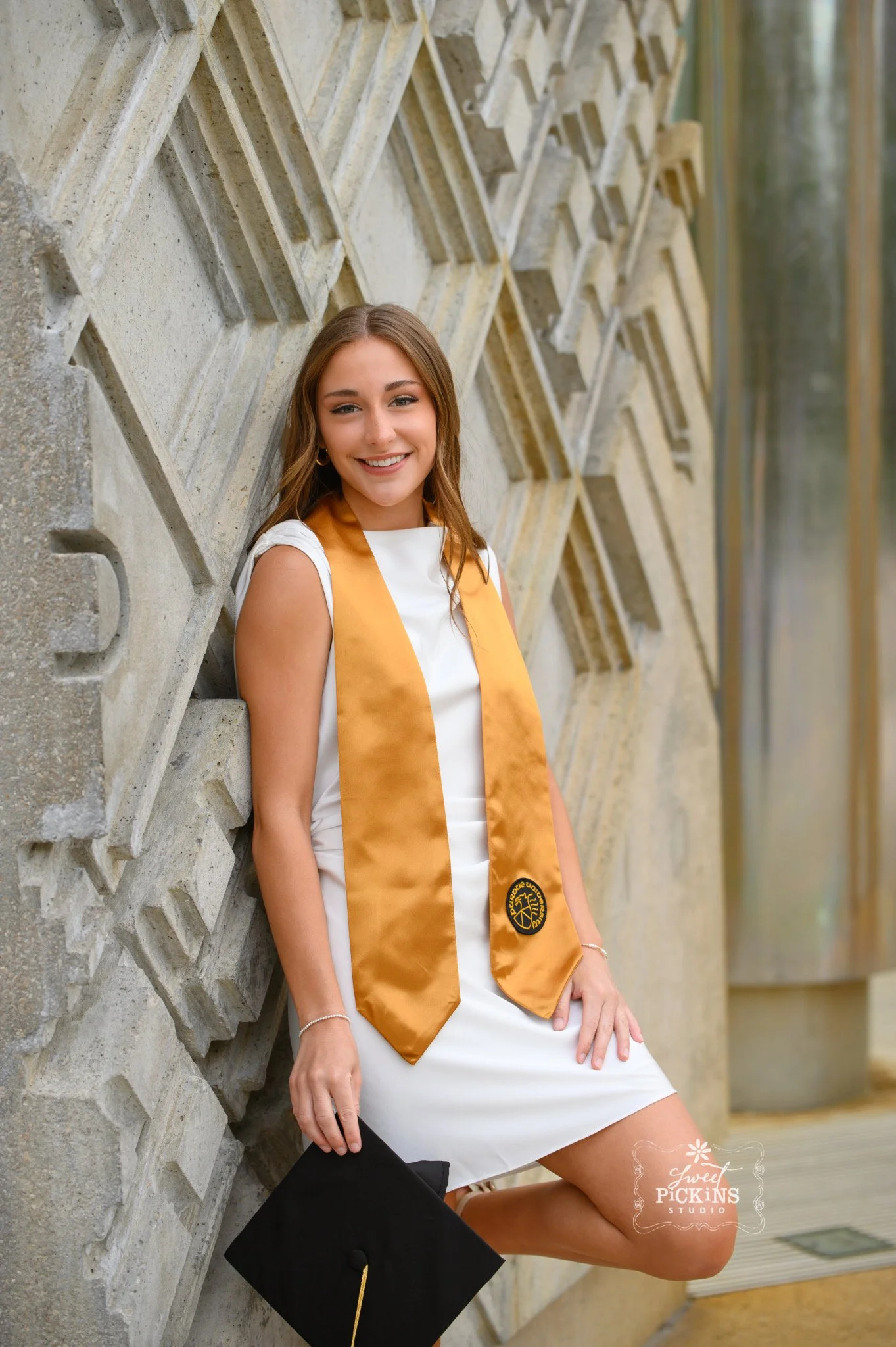 Purdue University Graduation Photography for Twins Class of 2026 Sisters pose at Memorial Union arch in West Lafayette, Indiana by Sweet Pickins Studio senior photographer Amanda Wilson ©