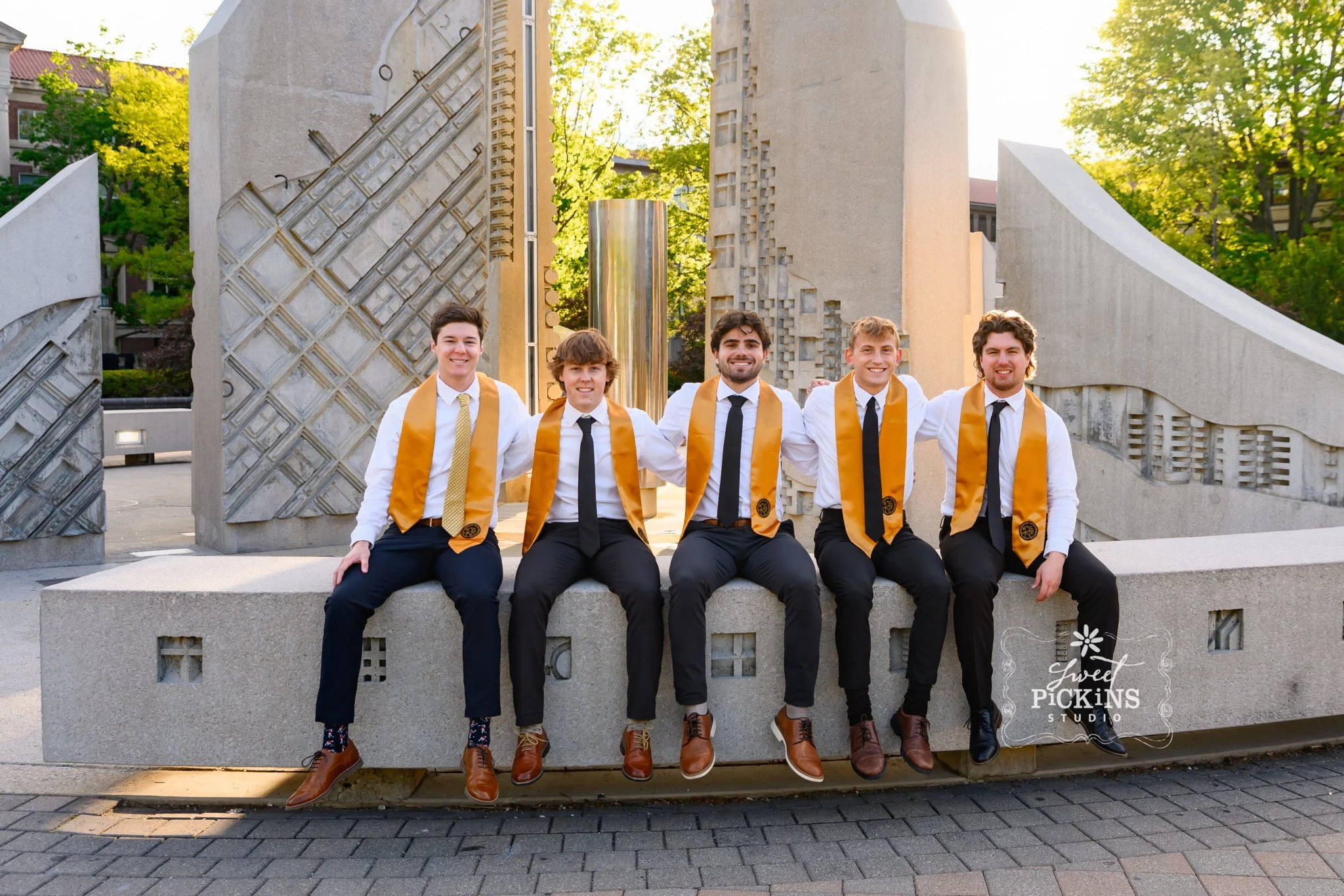 Purdue University Graduation Photography for Guys in Cap and Gown sitting on college campus by Sweet Pickins Studio senior photographer Amanda Wilson ©