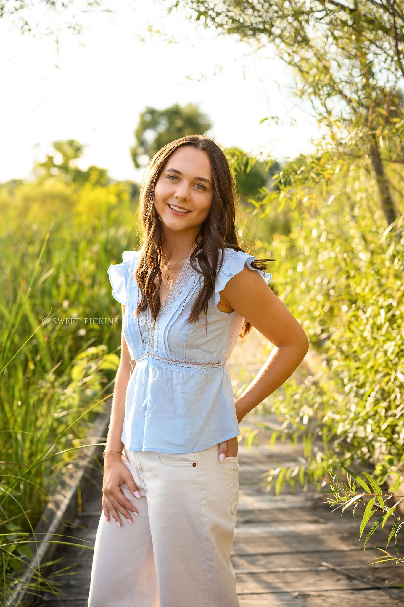Sophie’s Carmel, Indiana Senior Portrait Photography by Sweet Pickins Studio senior photographer Amanda Wilson for class of 2027 Senior girl posing in blue eyelet top and white jeans in nature park ©