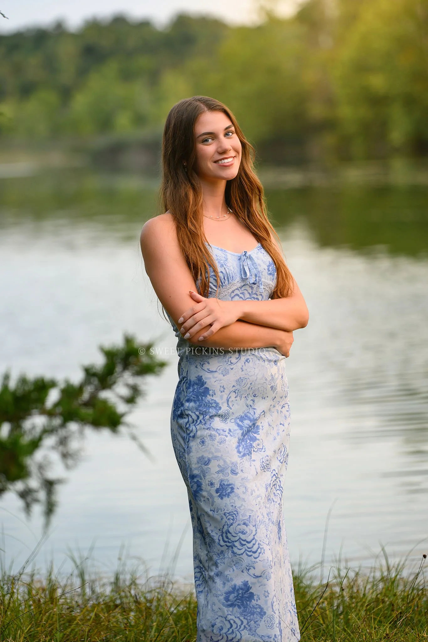 Taylor | Indiana Senior Girl Photography for class of 2027 senior by lake at sunset wearing blue floral dress by Sweet Pickins Studio senior photographer Amanda Wilson ©