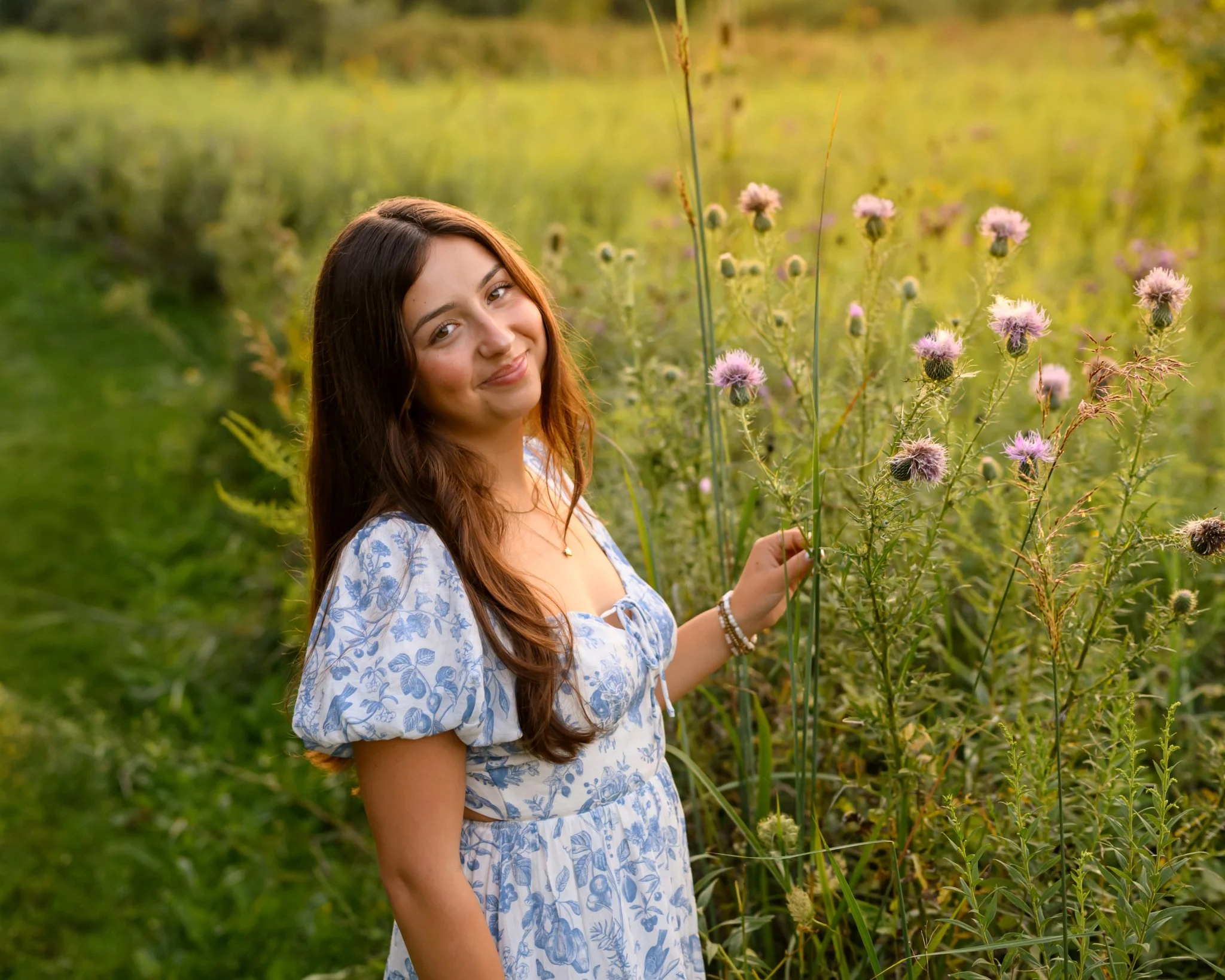 Maisie | Lakeville, Indiana Senior Portrait Photography in Flower Field for Madison East High School class of 2027 senior girl posing in blue floral dress by Peru Indiana senior photographer Amanda Wilson © Sweet Pickins Studio