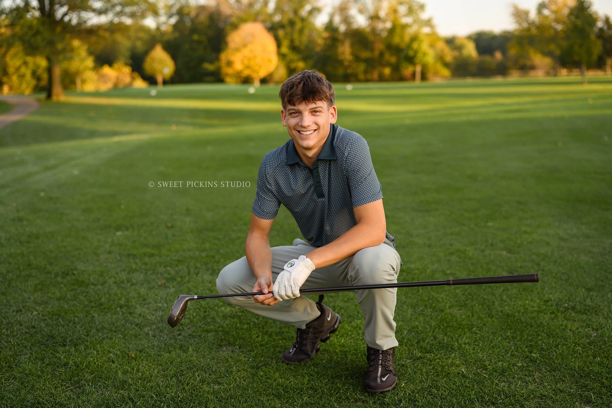 Cohen | Peru, Indiana Golf Senior Photography in Fall for Maconaquah High School Class of 2027 senior guy posing on golf course with driver by Sweet Pickins Studio senior photographer Amanda Wilson ©