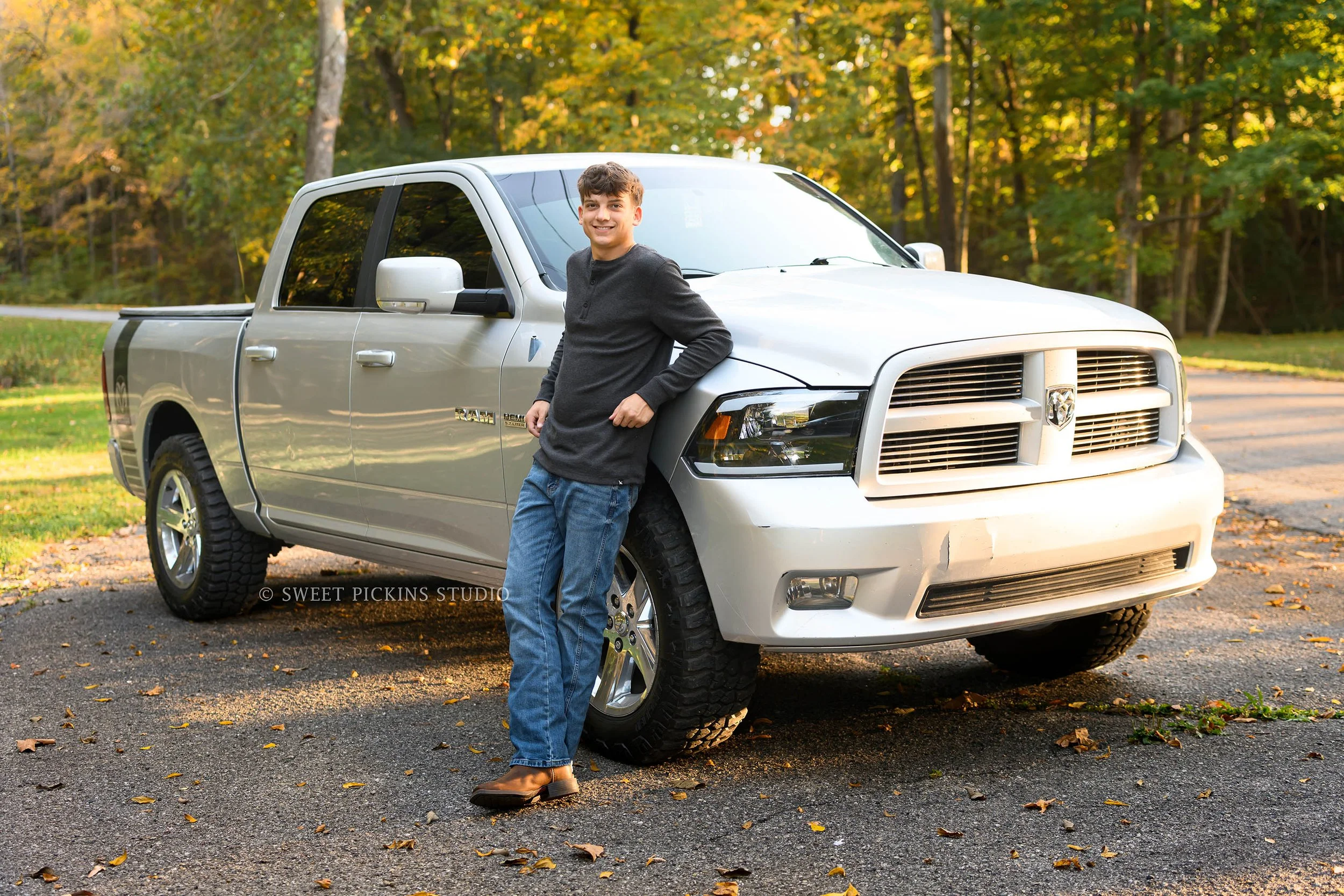 Cohen | Peru, Indiana Fall Senior Photography with truck at Maconaquah Park for Maconaquah High School Class of 2027 senior guy wearing gray waffle henley shirt and denim jeans with boots by Sweet Pickins Studio senior photographer Amanda Wilson ©