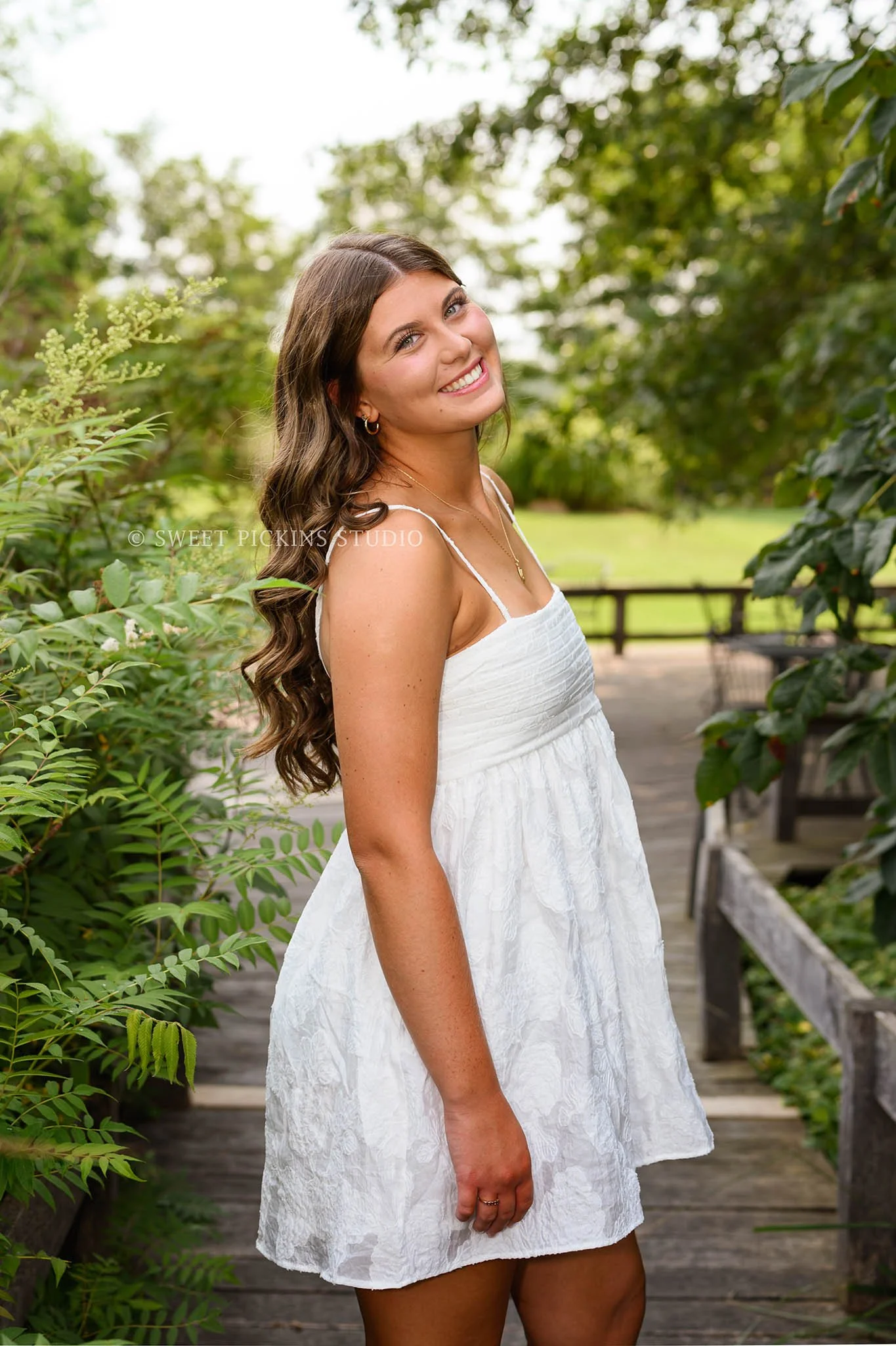 Zionsville, Indiana Country Senior Portrait Photography at Traders Point Creamery with class of 2027 senior girl wearing white babydoll dress and red western boots by Sweet Pickins Studio senior photographer Amanda Wilson ©