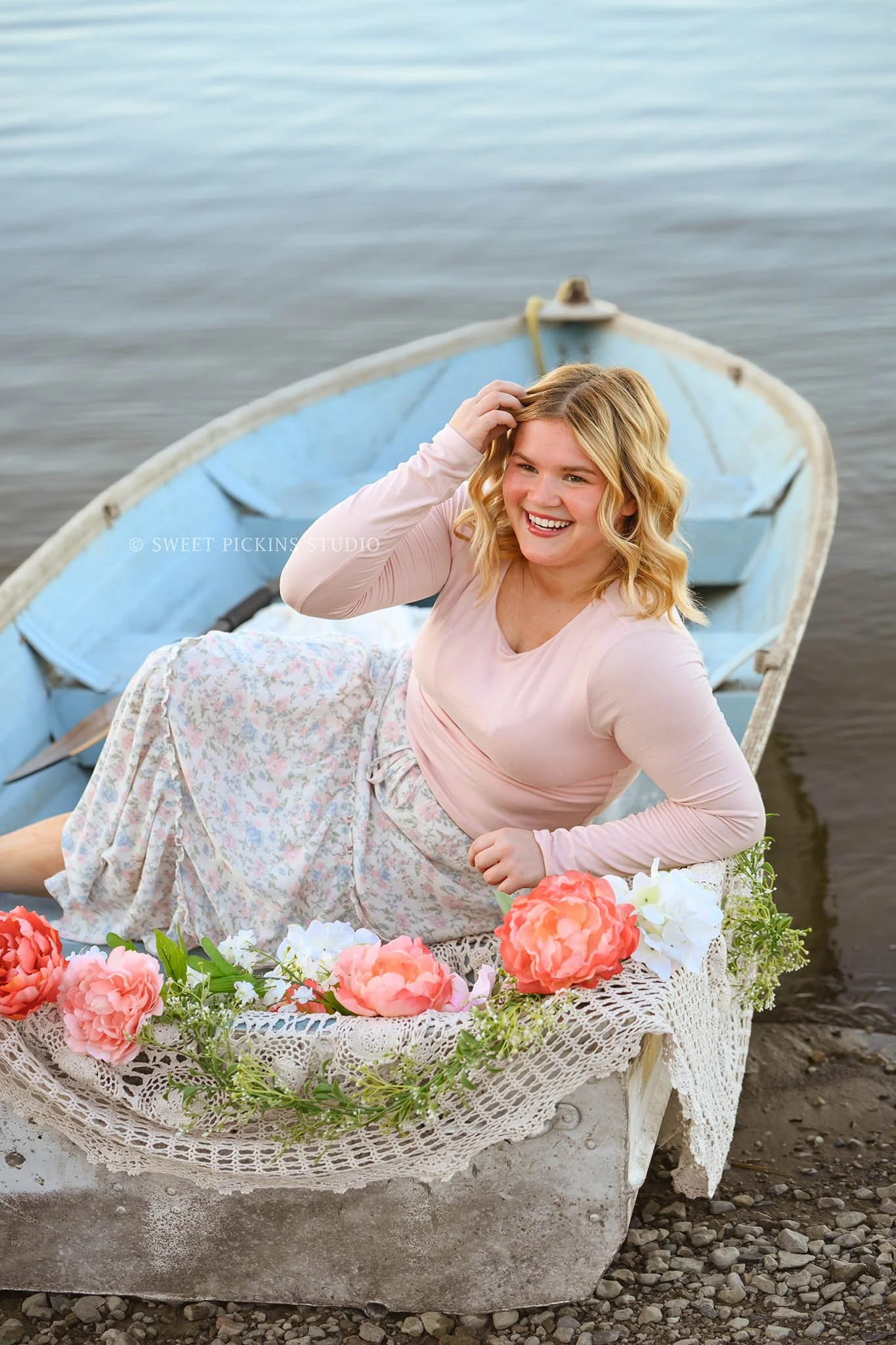 Rilynn’s Peru, Indiana Senior Portrait Photography in Boat with pastel flowers at the lake for Maconaquah High School class of 2027 senior girl wearing floral skirt by Sweet Pickins Studio senior photographer Amanda Wilson ©