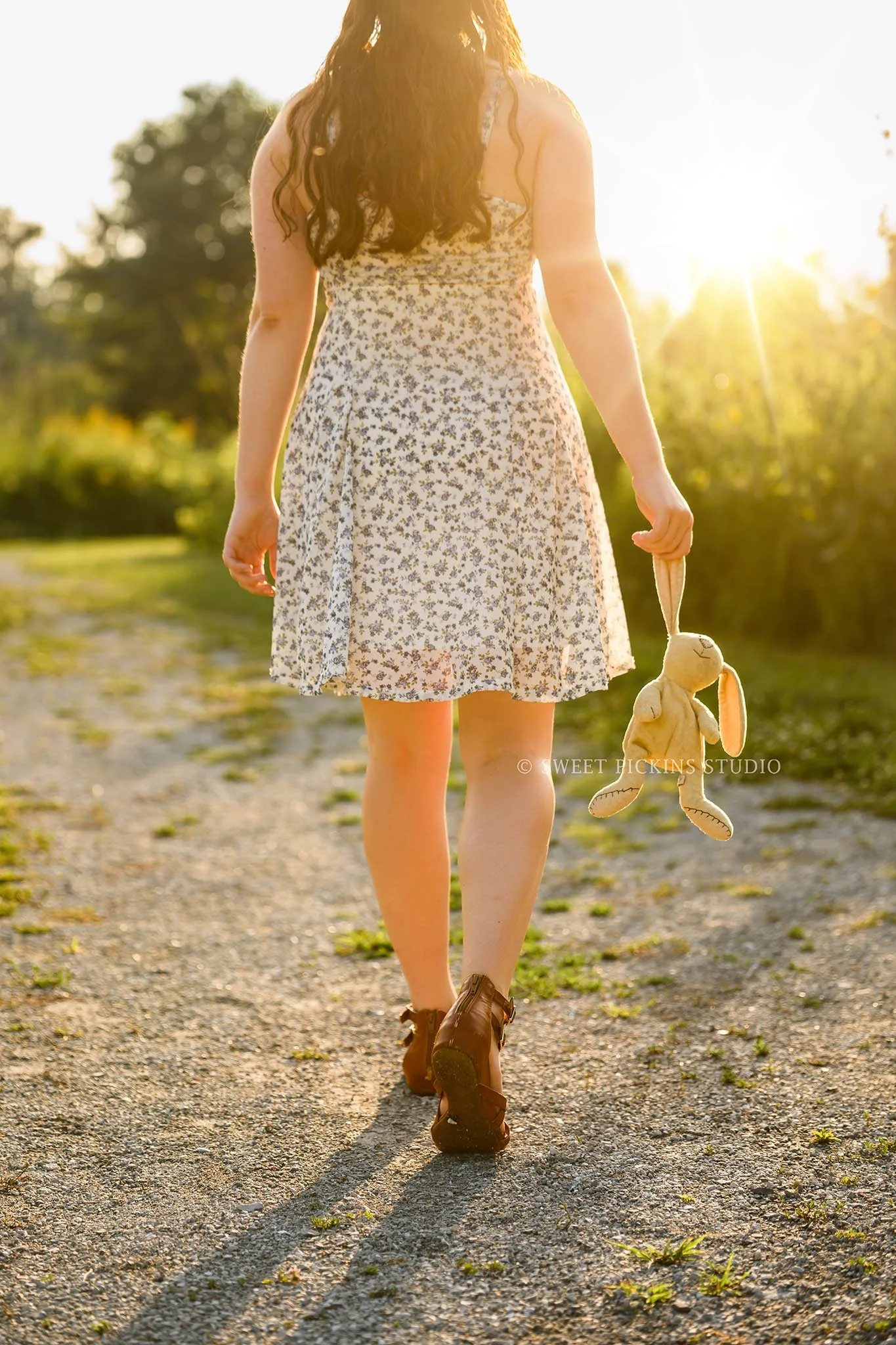 Carmel, Indiana Senior Photography for Class of 2027 Senior Ellen in Flower Field wearing floral dress with childhood stuffed animal by Sweet Pickins Studio senior photographer Amanda Wilson ©