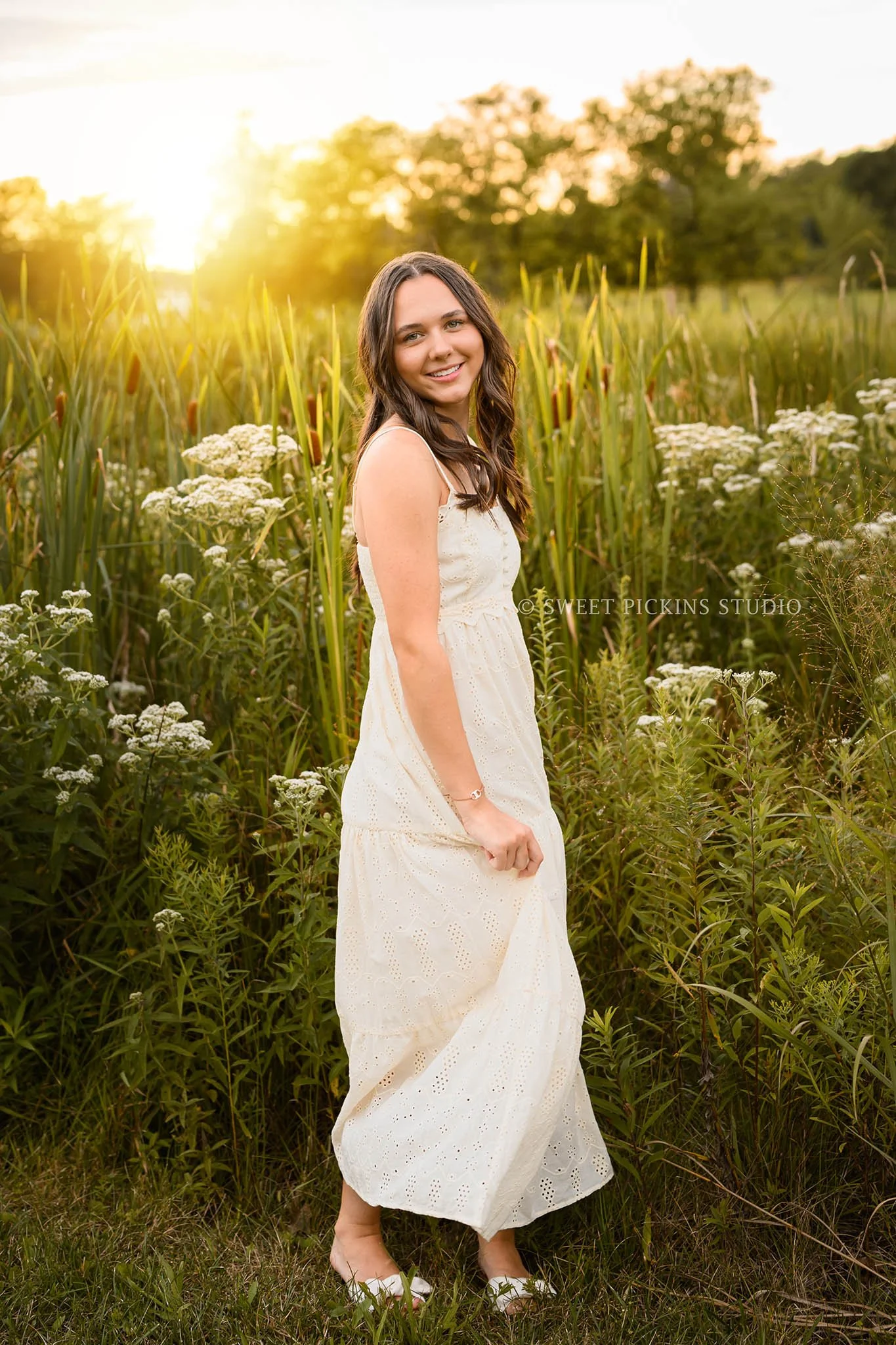 Sophie’s Carmel, Indiana Senior Photography by Sweet Pickins Studio senior photographer Amanda Wilson for class of 2027 Senior girl posing in cream maxi dress at sunset ©