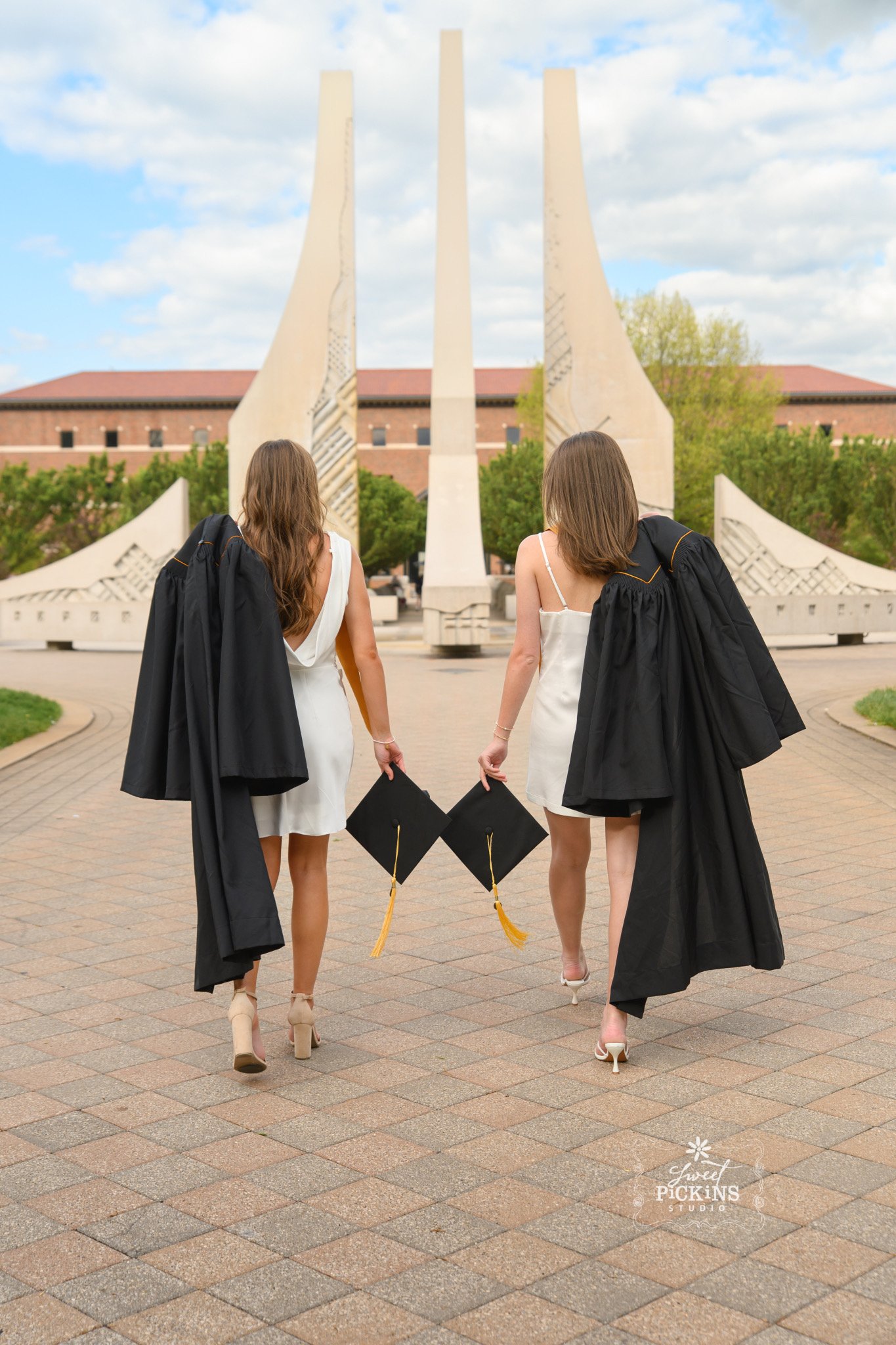 Purdue University Graduation Photography for Twins Class of 2026 Sisters pose at campus fountain in West Lafayette, Indiana by Sweet Pickins Studio senior photographer Amanda Wilson ©
