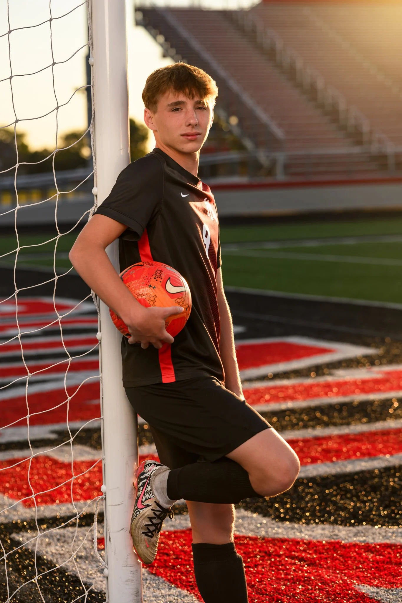Huntington, Indiana Soccer Senior Photography for Huntington North Class of 2027 sports athlete BOSTAN at stadium by soccer goal by Sweet Pickins Studio senior photographer Amanda Wilson ©