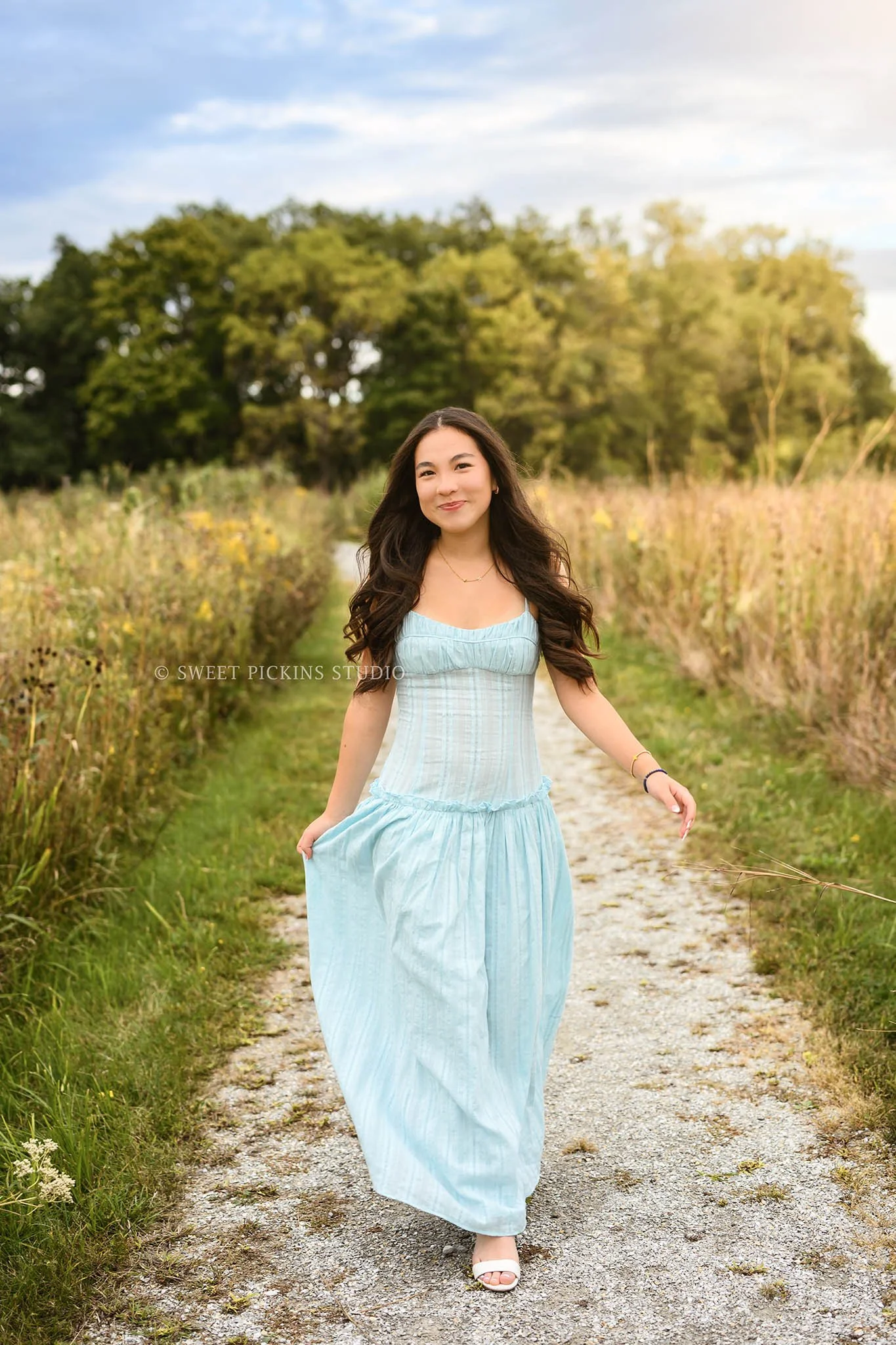 Nora | Carmel, Indiana Senior Girl Pictures posing on nature path in golden grass wearing blue dress for Park Tudor Class of 2027 by Sweet Pickins Studio senior photographer Amanda Wilson ©