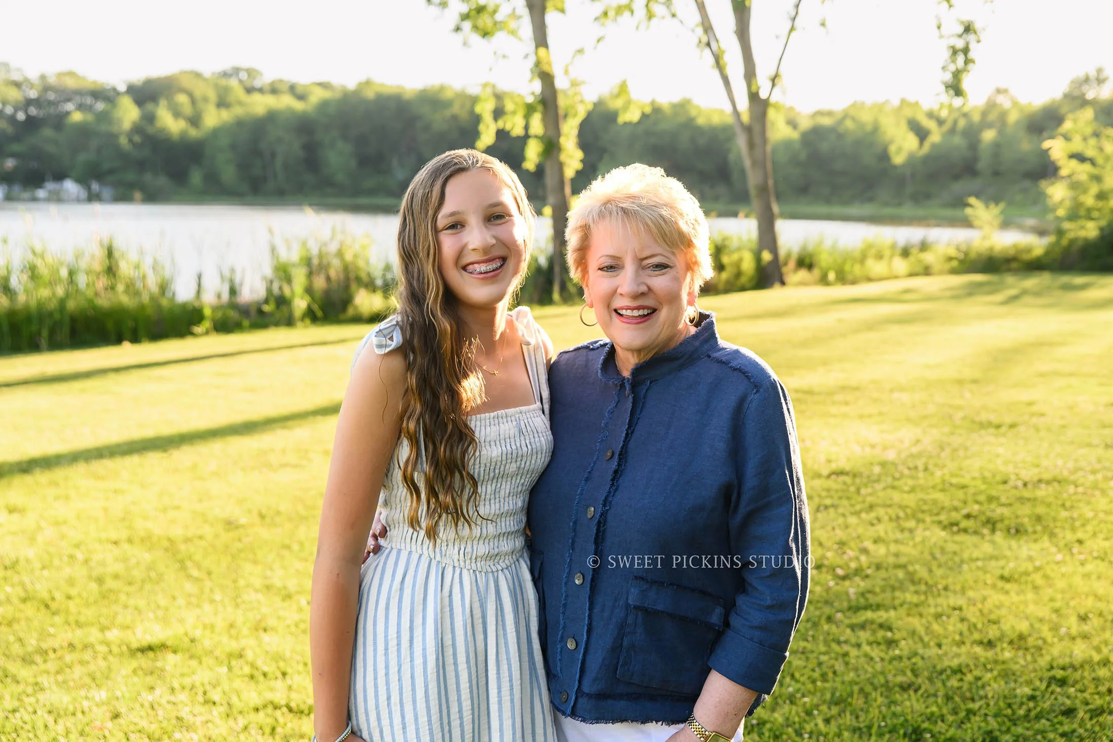 Roann, Indiana Grandparent Photography of grandmother with granddaughter wearing blue and beige outfits at Luken’s Lake outdoor nature location in summer by Sweet Pickins Studio family photographer Amanda Wilson ©
