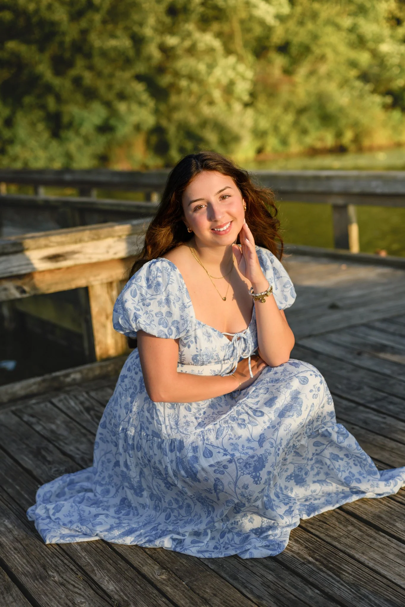 Maisie | Lakeville, Indiana Senior Pictures at the Lake for Madison East High School class of 2027 senior girl posing in floral dress on pier by Peru Indiana senior photographer Amanda Wilson © Sweet Pickins Studio
