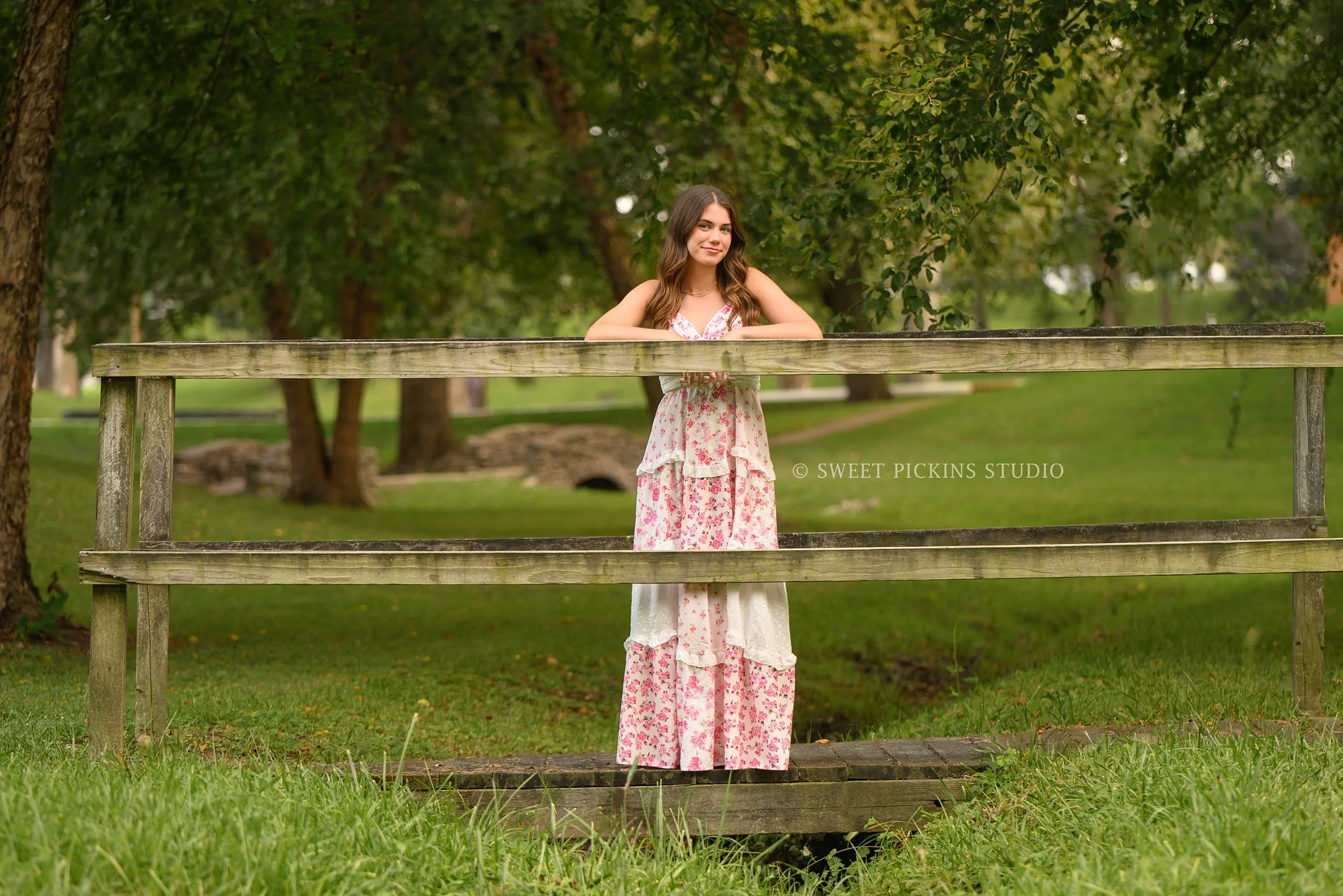 Taylor | Indiana Senior Girl Photography for class of 2027 senior posing on bridge wearing pink floral maxi dress by Sweet Pickins Studio senior photographer Amanda Wilson ©