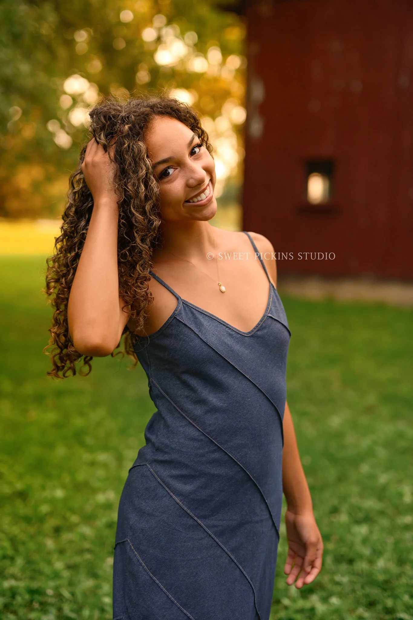 Madeline | Country Senior Photography for Class of 2027 senior girl with curly hair wearing denim jean dress by Peru Indiana Senior  photographer Amanda Wilson of Sweet Pickins Studio ©