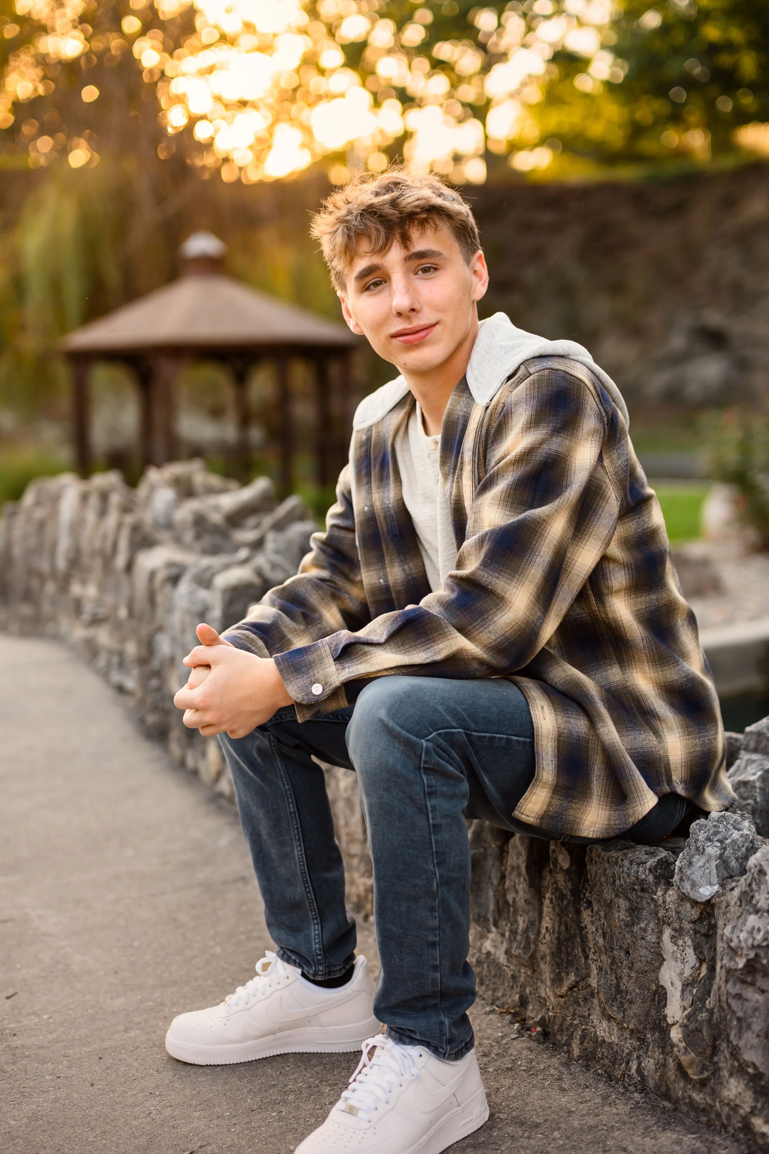 Huntington, Indiana Fall Senior Photography for Huntington North Class of 2027 senior guy BOSTAN leaning on tree at outdoor nature park wearing plaid flannel by Sweet Pickins Studio senior photographer Amanda Wilson ©
