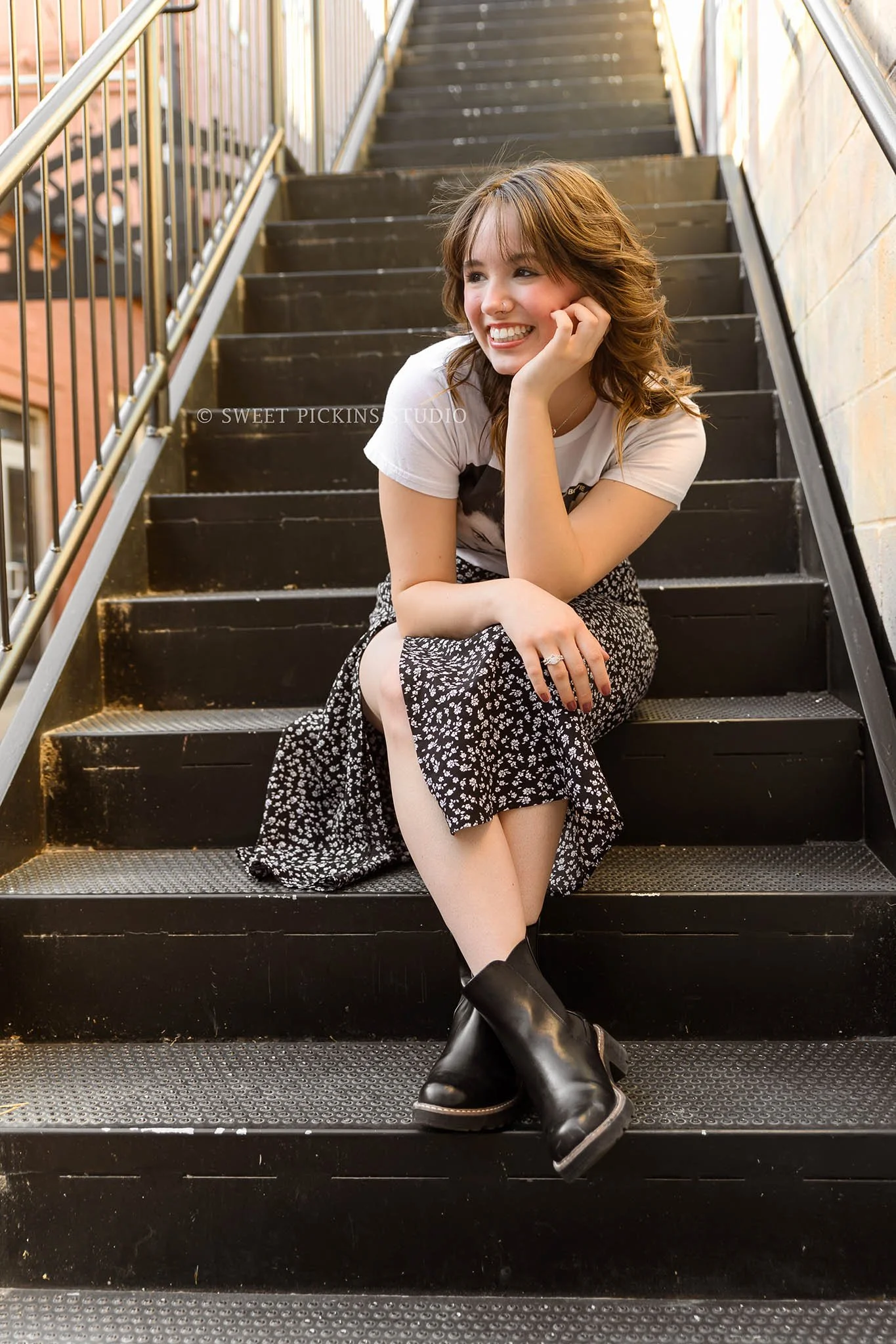 Hailee | Noblesville, Indiana Senior Picture Photography in Urban Downtown for Noblesville High School class of 2026 senior girl posing on black stair steps in graphic tee and skirt by Sweet Pickins Studio senior photographer Amanda Wilson © 2026
