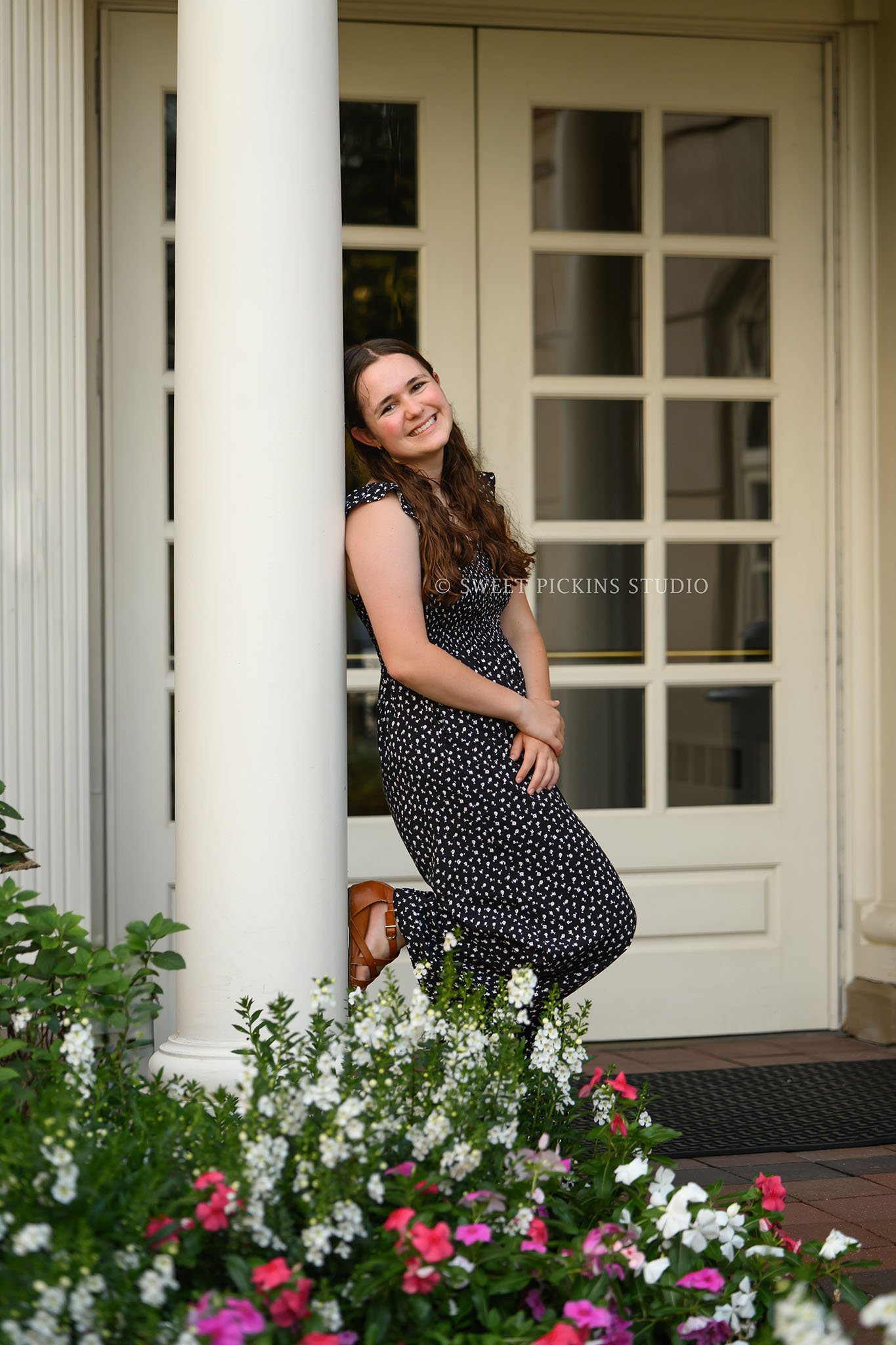 Downtown Carmel, Indiana Senior Photography for Class of 2027 Senior Ellen at city hall with flowers wearing floral romper by Sweet Pickins Studio senior photographer Amanda Wilson ©