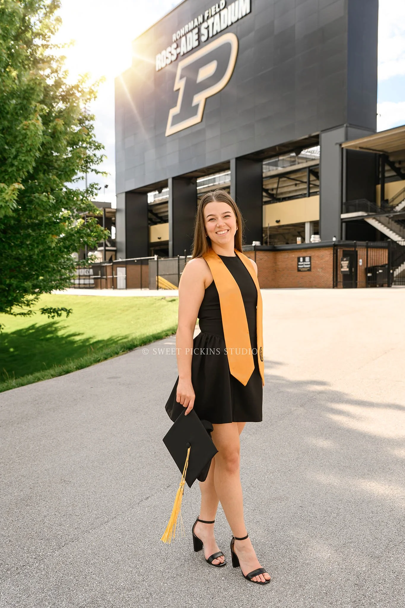 Ashelyn’s Purdue University Graduation Portrait Photography at Ross Ade Stadium for sports nutrition graduate wearing cap and gown in West Lafayette, Indiana by Sweet Pickins Studio senior photographer Amanda Wilson © 2026