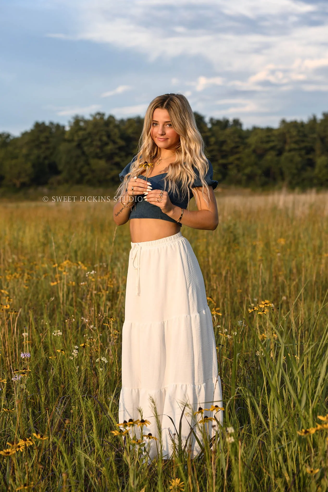 Addison’s Peru, Indiana Country Senior Photography in Prairie Flower Field at Sunset wearing denim top with white flowy skirt in nature location by Sweet Pickins Studio senior photographer Amanda Wilson  ©