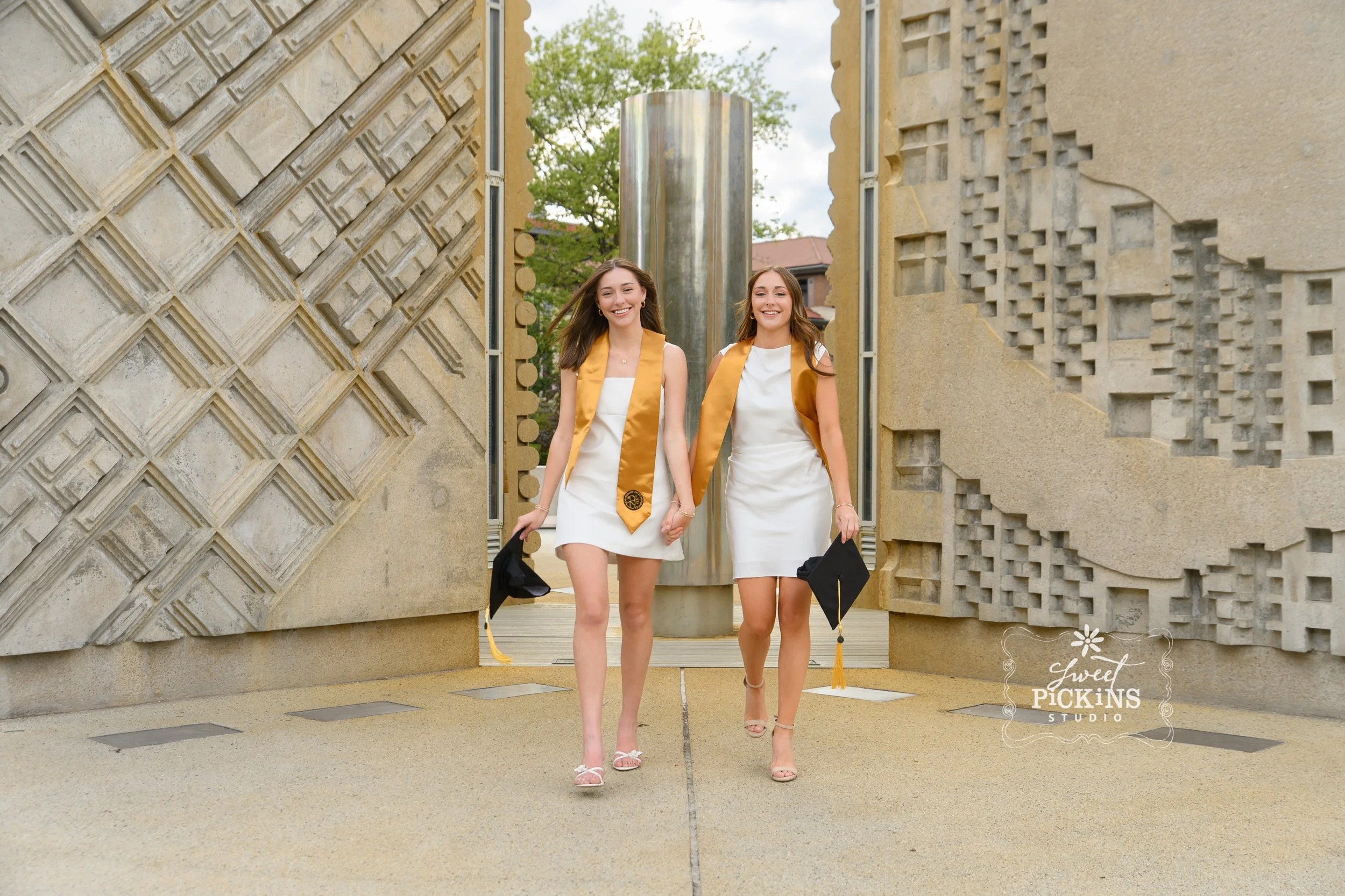 Purdue University Graduation Photography for Twins Class of 2026 Sisters pose at Engineering Fountain in West Lafayette, Indiana by Sweet Pickins Studio senior photographer Amanda Wilson ©