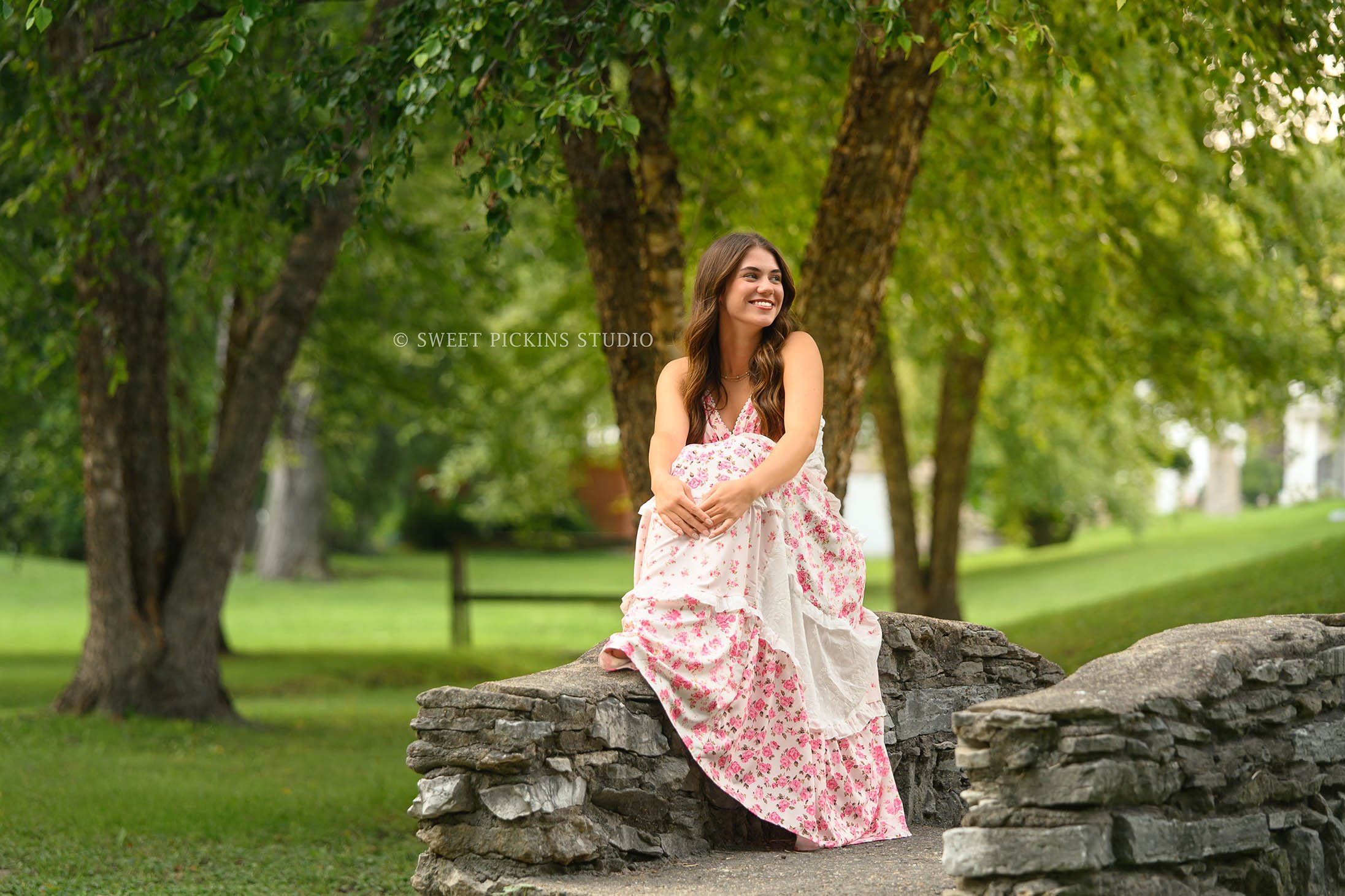 Taylor | Indiana Senior Girl Photography for class of 2027 senior posing on stone bridge wearing pink floral maxi dress by Sweet Pickins Studio senior photographer Amanda Wilson ©