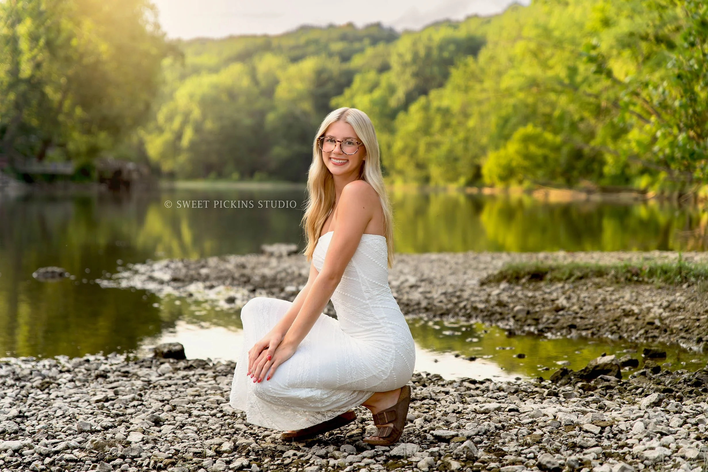 Kyree’s River Senior Photography in Peru, Indiana for Logansport High School Class of 2027 senior girl wearing white dress in river water in forest by Sweet Pickins Studio senior photographer Amanda Wilson ©