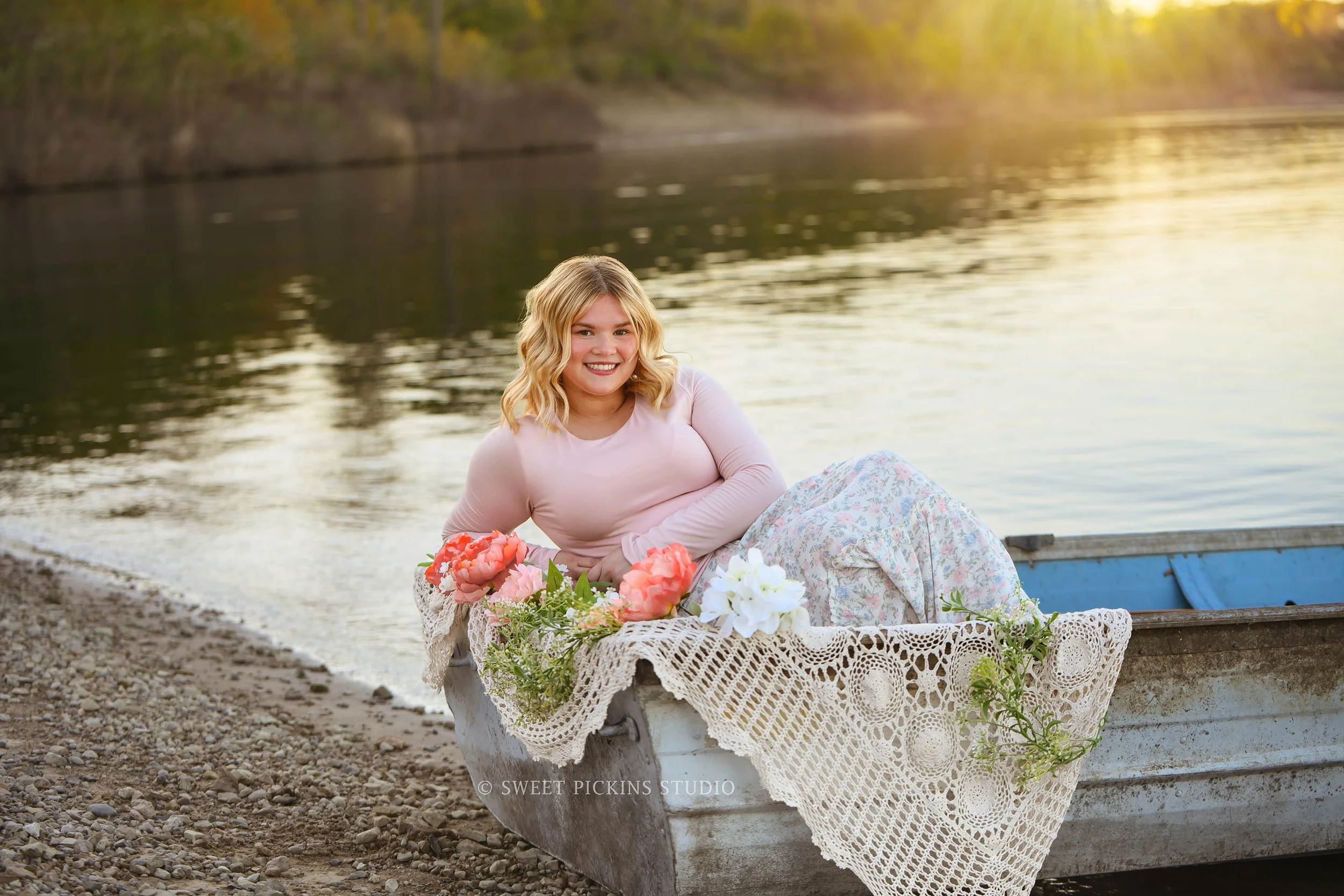 Rilynn’s Peru, Indiana Senior Portrait Photography in boat with boho flowers at the lake for Maconaquah High School class of 2027 senior girl wearing pastel floral skirt by Sweet Pickins Studio senior photographer Amanda Wilson ©
