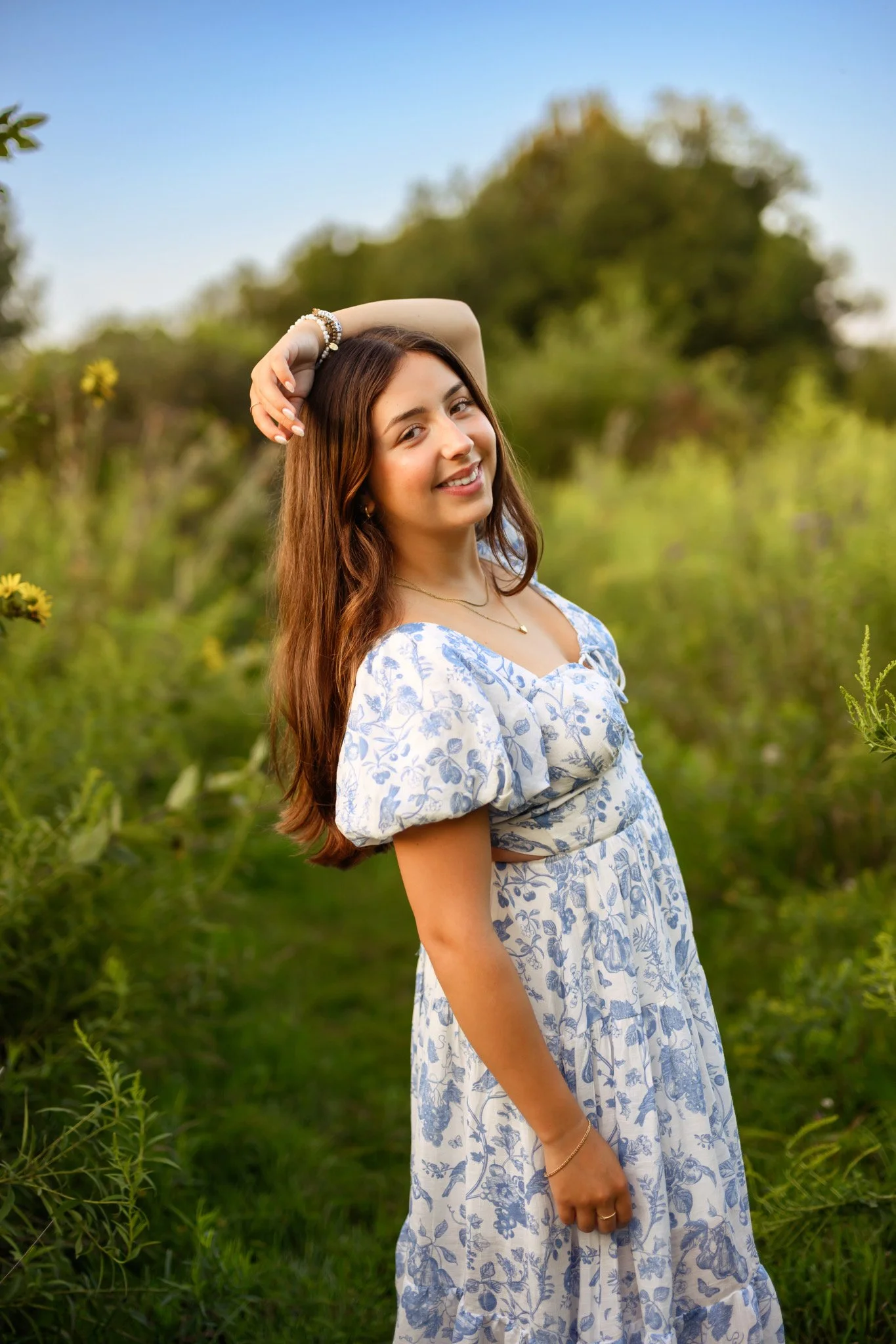 Maisie | Lakeville, Indiana Senior Pictures in Flower Field for Madison East High School class of 2027 senior girl posing in blue floral dress by Peru Indiana senior photographer Amanda Wilson © Sweet Pickins Studio