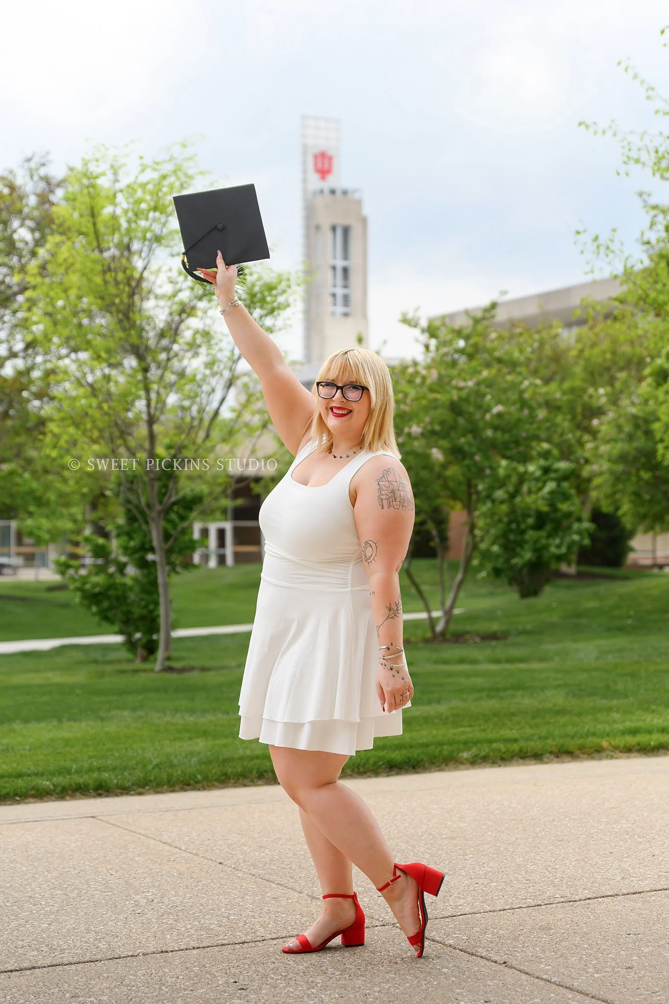 Indiana Univ at Indianapolis Graduation Photoshoot in Downtown Indianapolis, Indiana with class of 2026 graduate wearing white dress and red heels by Sweet Pickins Studio senior photographer Amanda Wilson ©