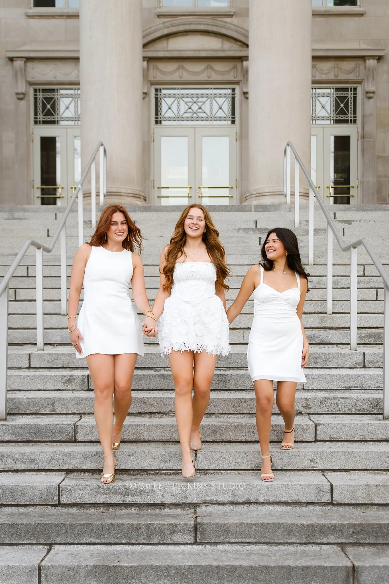 Purdue University Graduation Pictures for Sorority Sisters in West Lafayette, IN by Sweet Pickins Studio senior photographer Amanda Wilson for class of 2026 posing in white dresses with Alpha Beta stoles at Engineering fountain © 2026