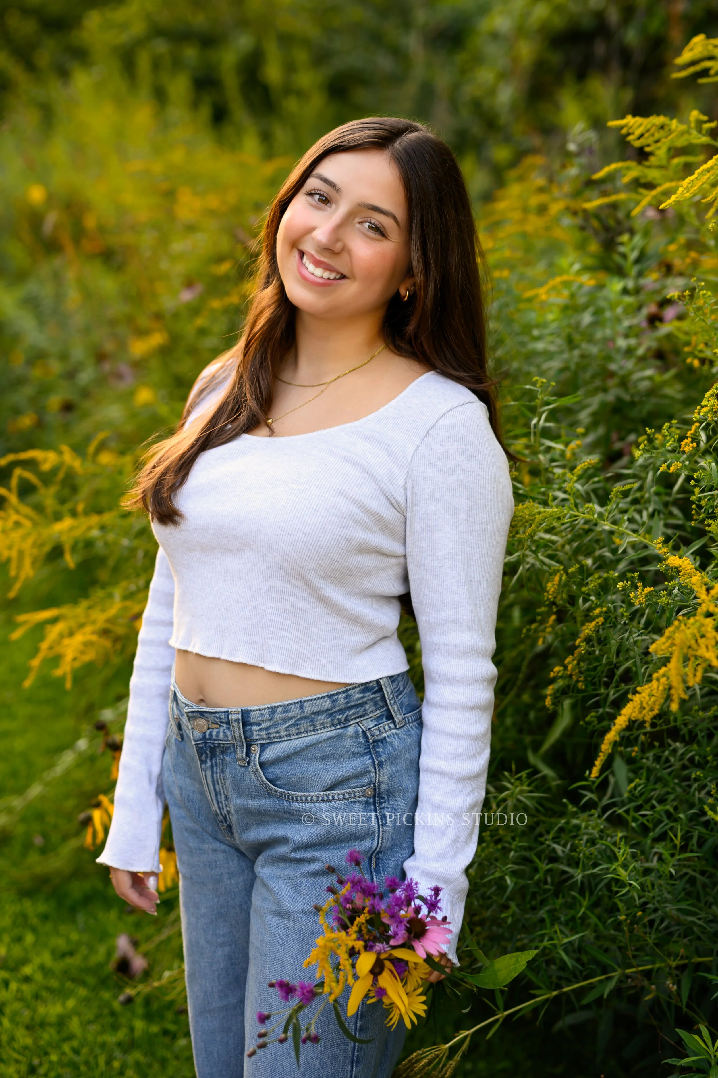 Maisie | Lakeville, Indiana Senior Portrait Photography in Flower Field for Madison East High School class of 2027 senior girl posing in denim jeans and crop top by Peru Indiana senior photographer Amanda Wilson © Sweet Pickins Studio