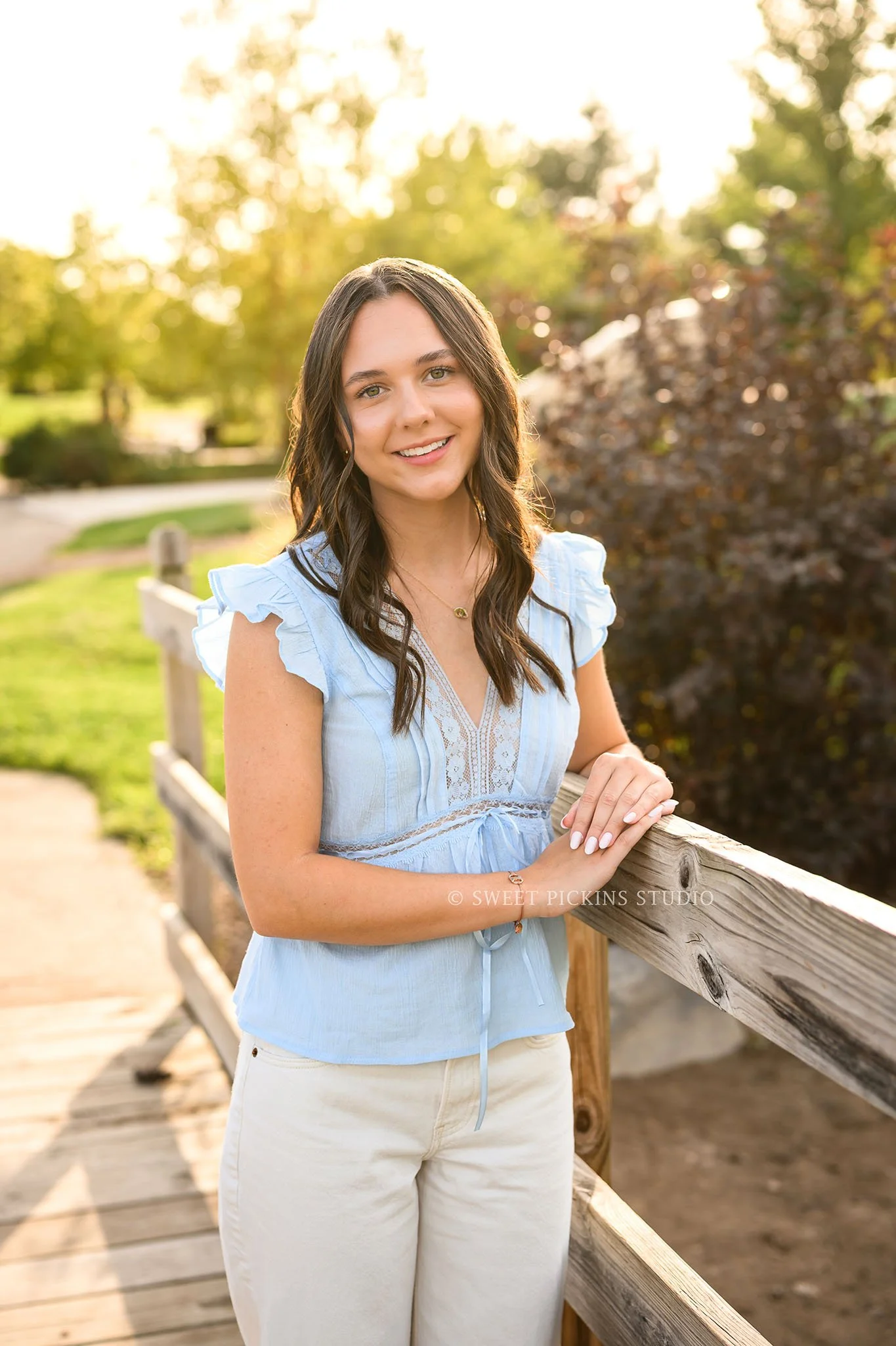 Sophie’s Carmel, Indiana Senior Portrait Photography by Sweet Pickins Studio senior photographer Amanda Wilson for class of 2027 Senior girl posing in blue eyelet top and white jeans in nature park ©