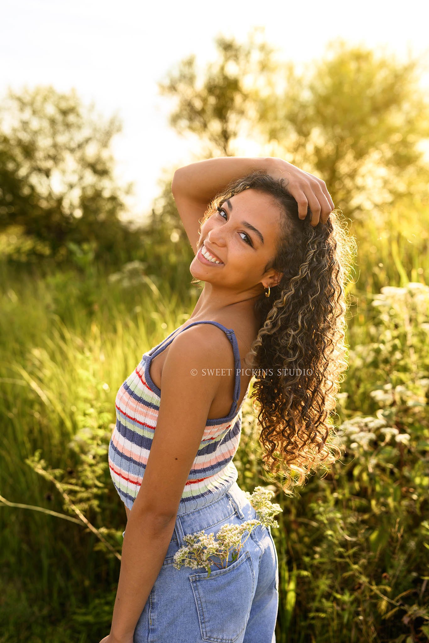 Madeline | Indiana Senior Girl Photography posing in flower field for Speedway High School Class of 2027 wearing striped tank top and denim shorts by Sweet Pickins Studio senior photographer Amanda Wilson ©