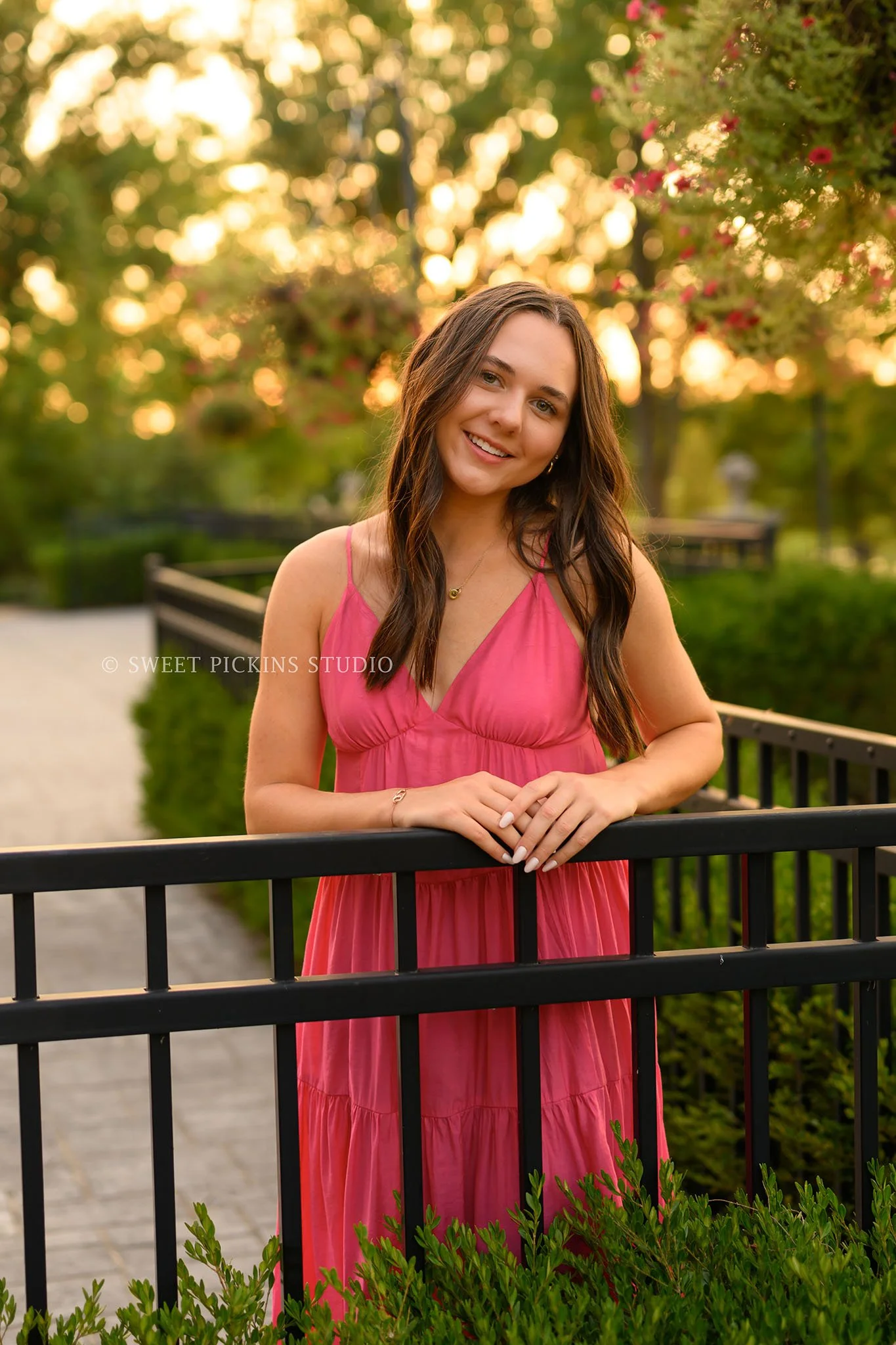 Sophie’s Carmel, Indiana Senior Photography by Sweet Pickins Studio senior photographer Amanda Wilson for class of 2027 Senior girl posing in pink maxi dress in golden grass at sunset ©