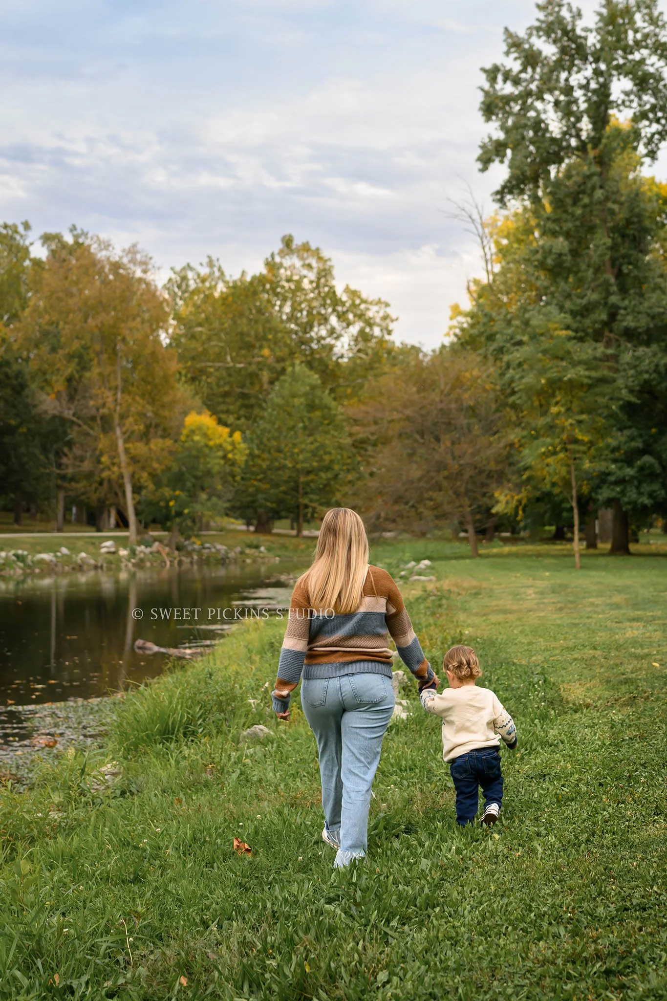 Kokomo, Indiana Fall Family Photography at Highland Park for Mommy and Son walking in autumn leaves by creek by Sweet Pickins Studio photographer Amanda Wilson ©
