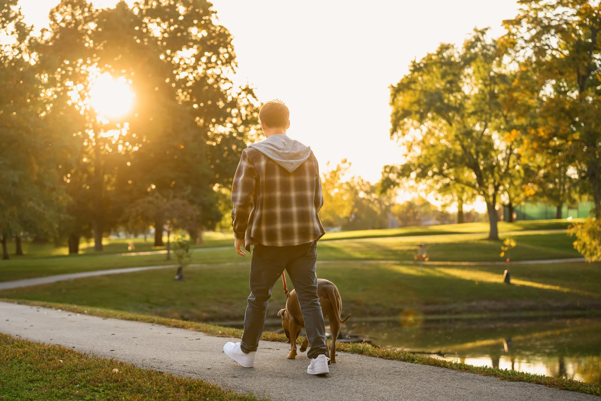 Huntington, Indiana Fall Senior Photography for Huntington North Class of 2027 senior guy BOSTAN walking dog at outdoor nature park wearing plaid flannel by Sweet Pickins Studio senior photographer Amanda Wilson ©