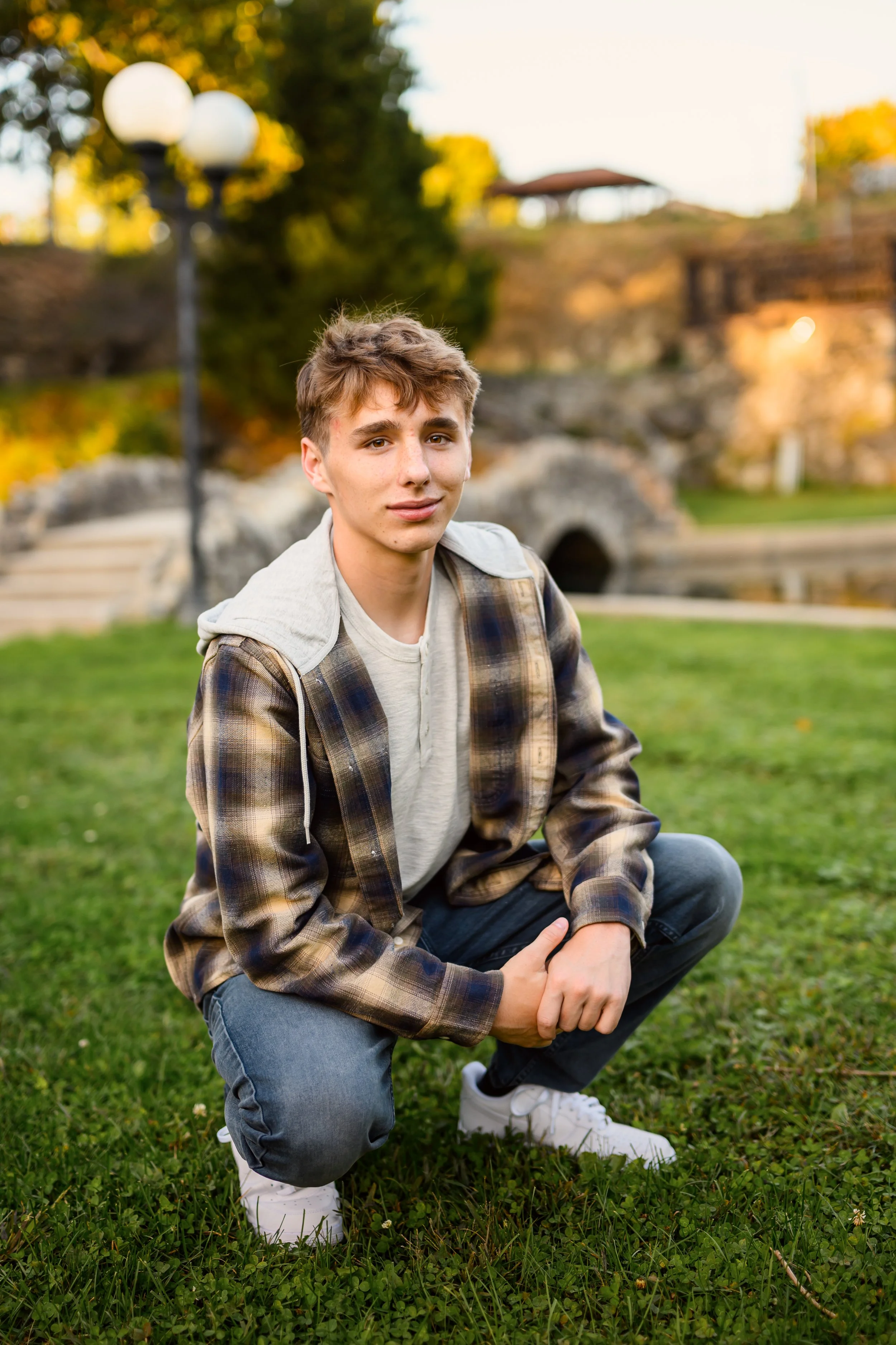 Huntington, Indiana Fall Senior Photography for Huntington North Class of 2027 senior guy BOSTAN leaning on tree at outdoor nature park wearing plaid flannel by Sweet Pickins Studio senior photographer Amanda Wilson ©
