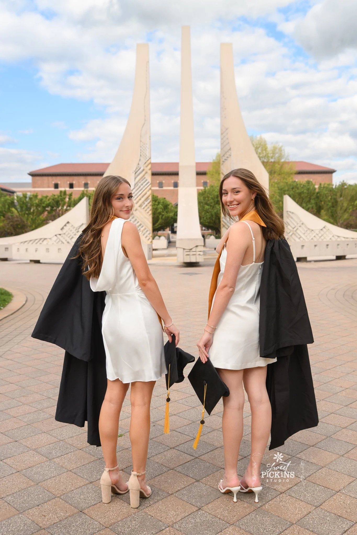Purdue University Graduation Photography for Twins Class of 2026 Sisters pose at Engineering Fountain in West Lafayette, Indiana by Sweet Pickins Studio senior photographer Amanda Wilson ©