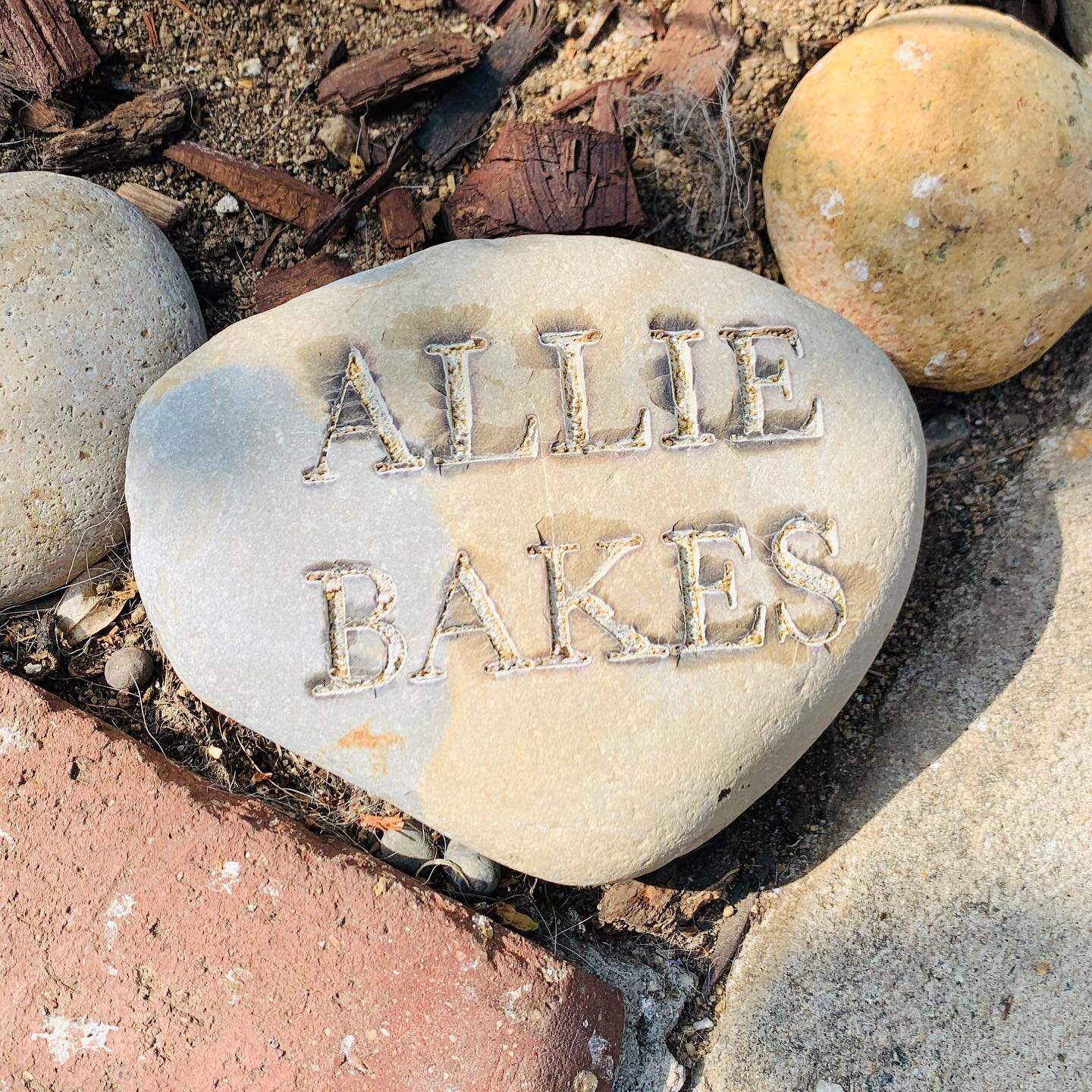 Covering a sweet custom rock present from my friend Denise. She had it custom made with the help of another work friend. One day it will adorn a bake sale table. For now I am treasuring it in my garden for people to see when they stop by. Thank you D