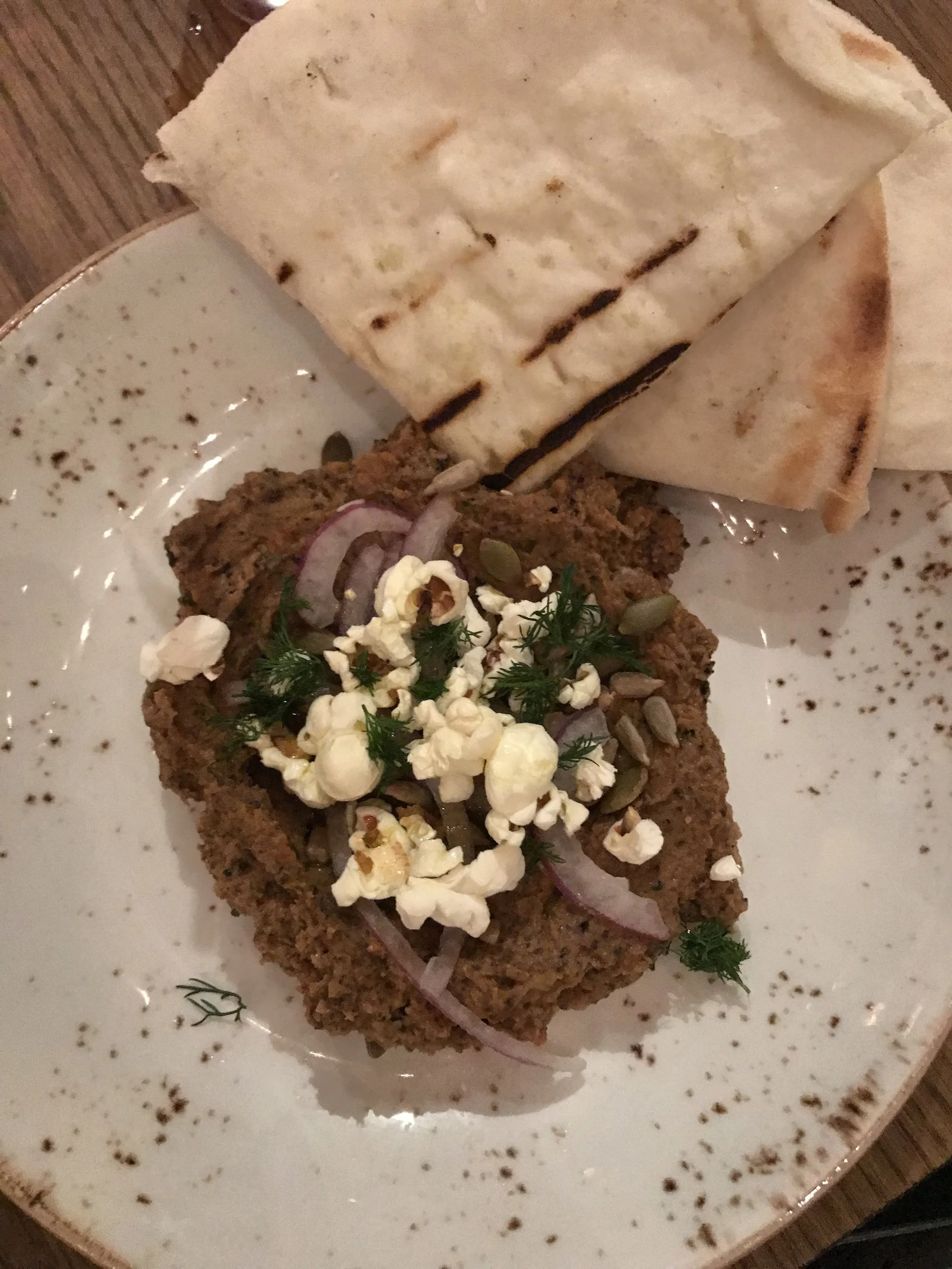 The cauliflower hummus at The Little Beet Table is served with gluten free pita and is topped with red onion, dill, popped sorghum, sunflower seeds and pumpkin seeds for added crunch.