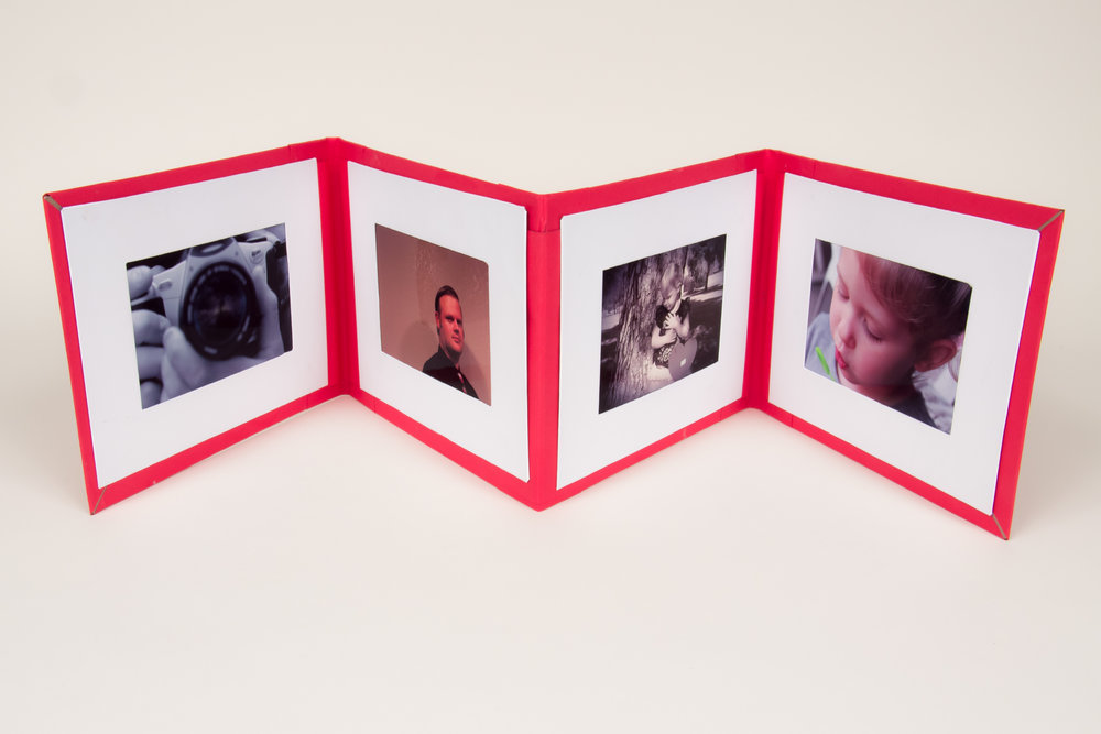  interior view of photo album display book. each photo was taken by the student and then inserted into the frames for part of the presentation.&nbsp; 