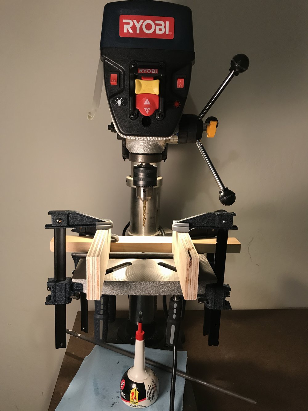  my drill press setup with clamps and lubrication oil. 