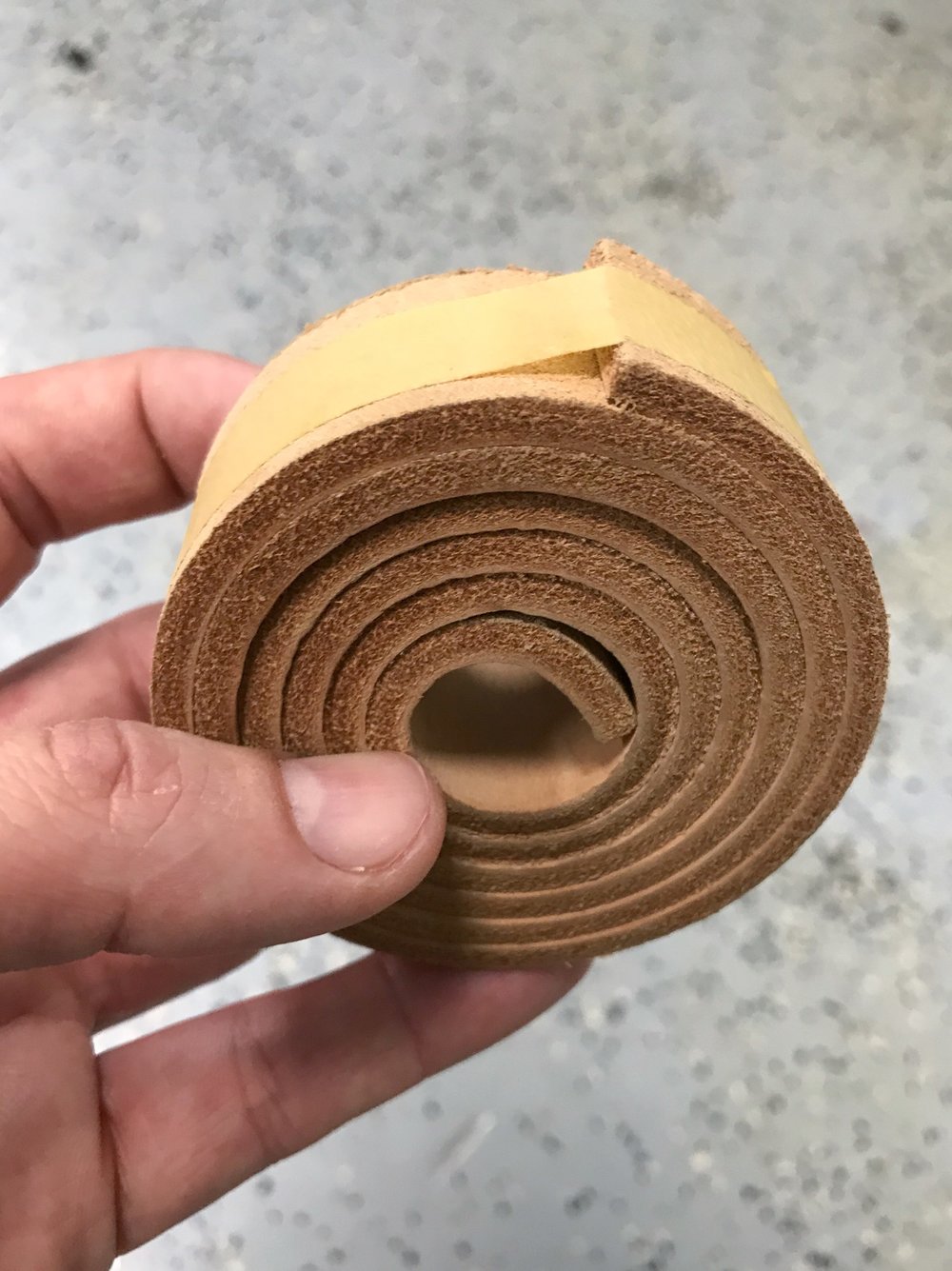 this is the unused leather strap that goes on the scraper bar for lithography. the other side of the leather is smooth for going across a greased tympan when printing lithos.  