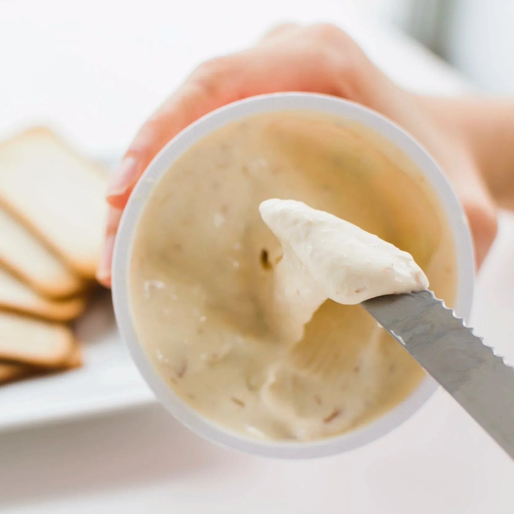 close-up-woman-s-hand-taking-creamy-cheese-spread-with-knife.jpg (Copy)