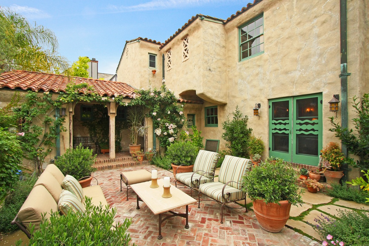 The interior front courtyard which can be accessed from the living room or the front loggia is surrounded by two Sally Holmes climbing roses, a mature Cecil Bruner rose which follows the line of the tops of the courtyard walls. A new herringbone pattern brick patio replaced a bizarre circular brick patio. An original Batchelder fountain and spout is installed at the end of the courtyard. The fountain, which drained water out to the storm drain, was retrofitted with a circulating pump. 