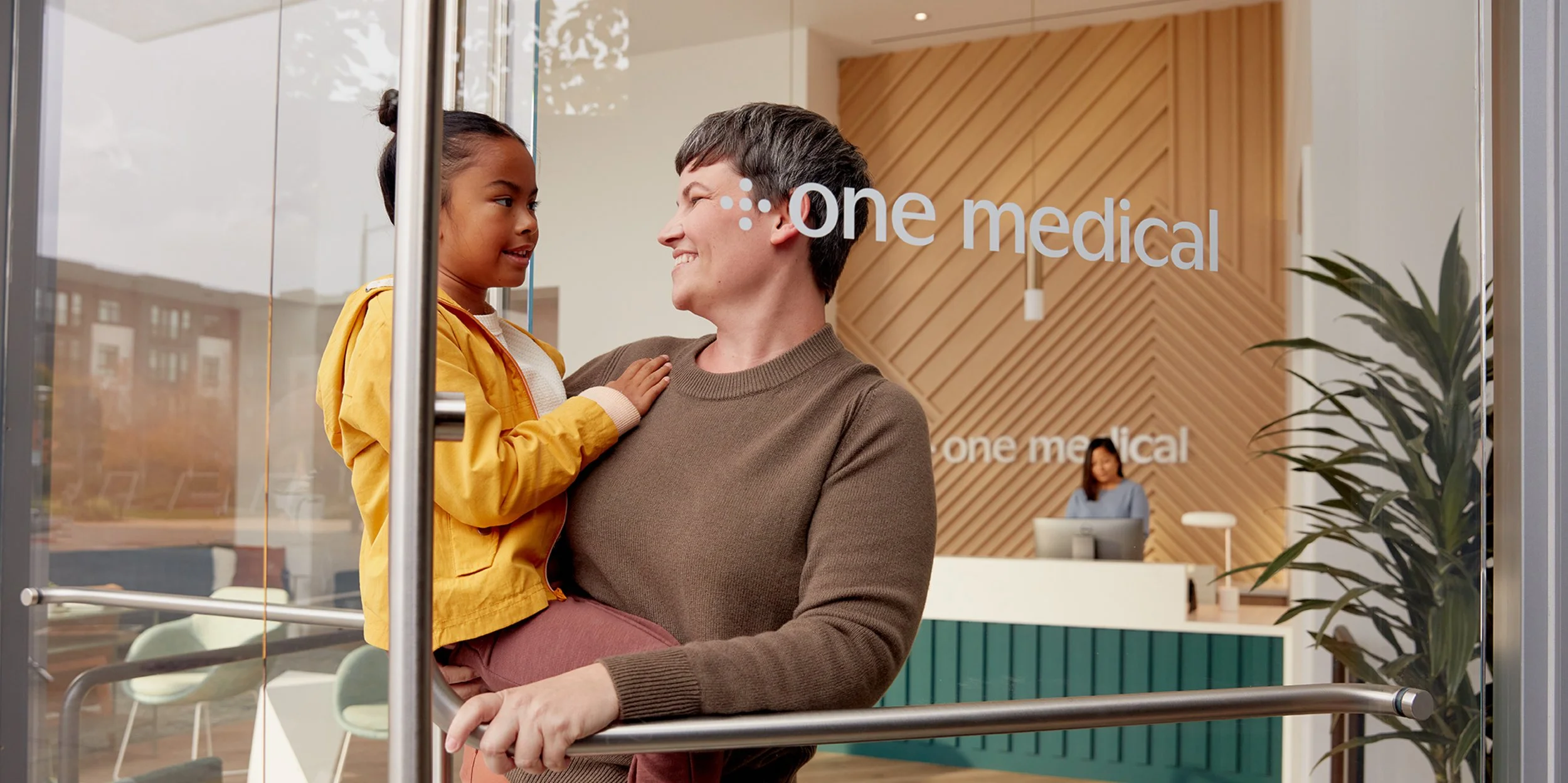 Mother and daughter leaving a One Medical office