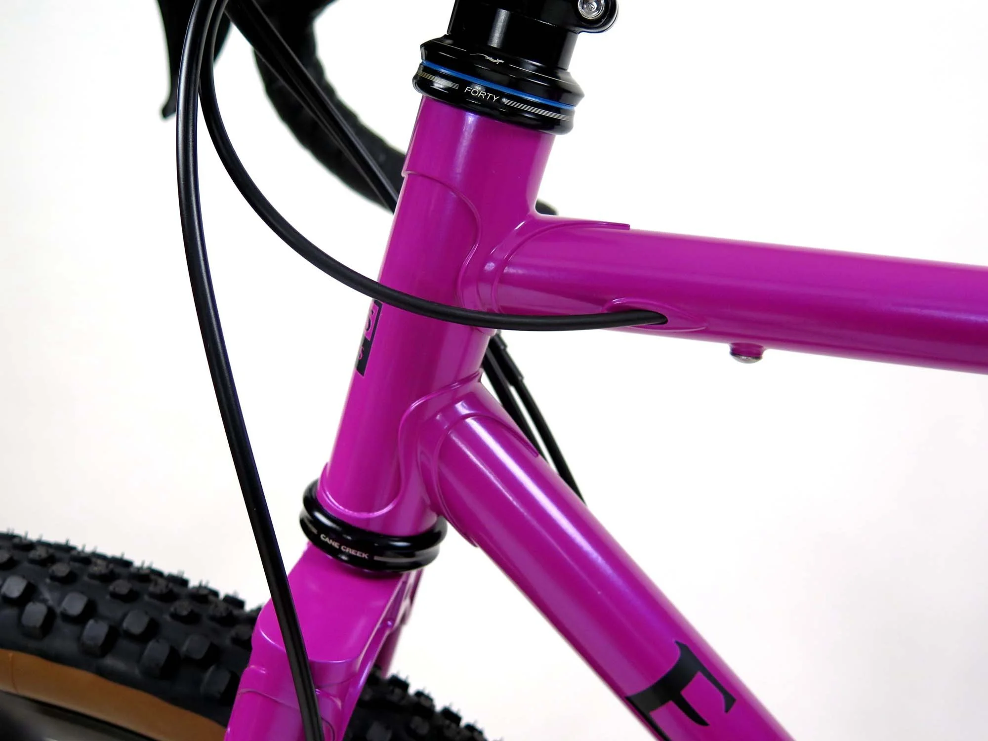  A head tube extension helps get the handlebars a bit higher without a huge stack of spacers, and the rear derailleur housing ducks into the top tube cleanly.  I also added bosses under the top tube for a future framebag. 