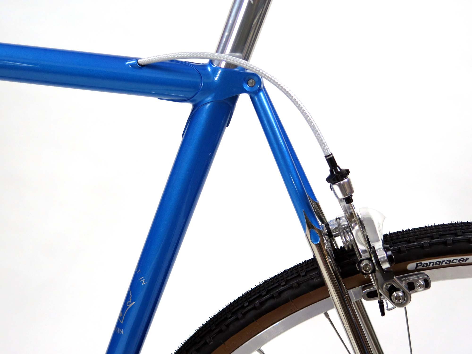  A graceful curve of housing from the top tube internal to the rear brake.   